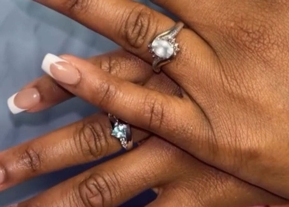 Stylish French manicure with rings at PolishedByQ, Beltsville, Maryland, US.