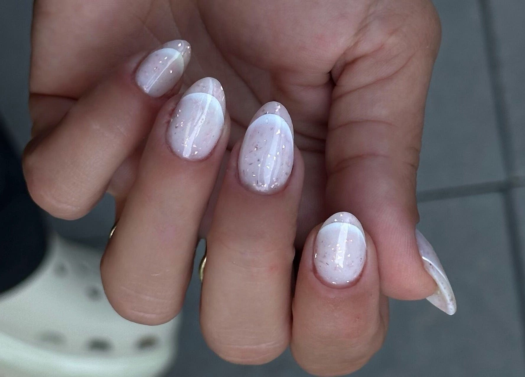 Elegant white manicure with glitter at My Balance nail studio in Thornhill, Ontario, CA.