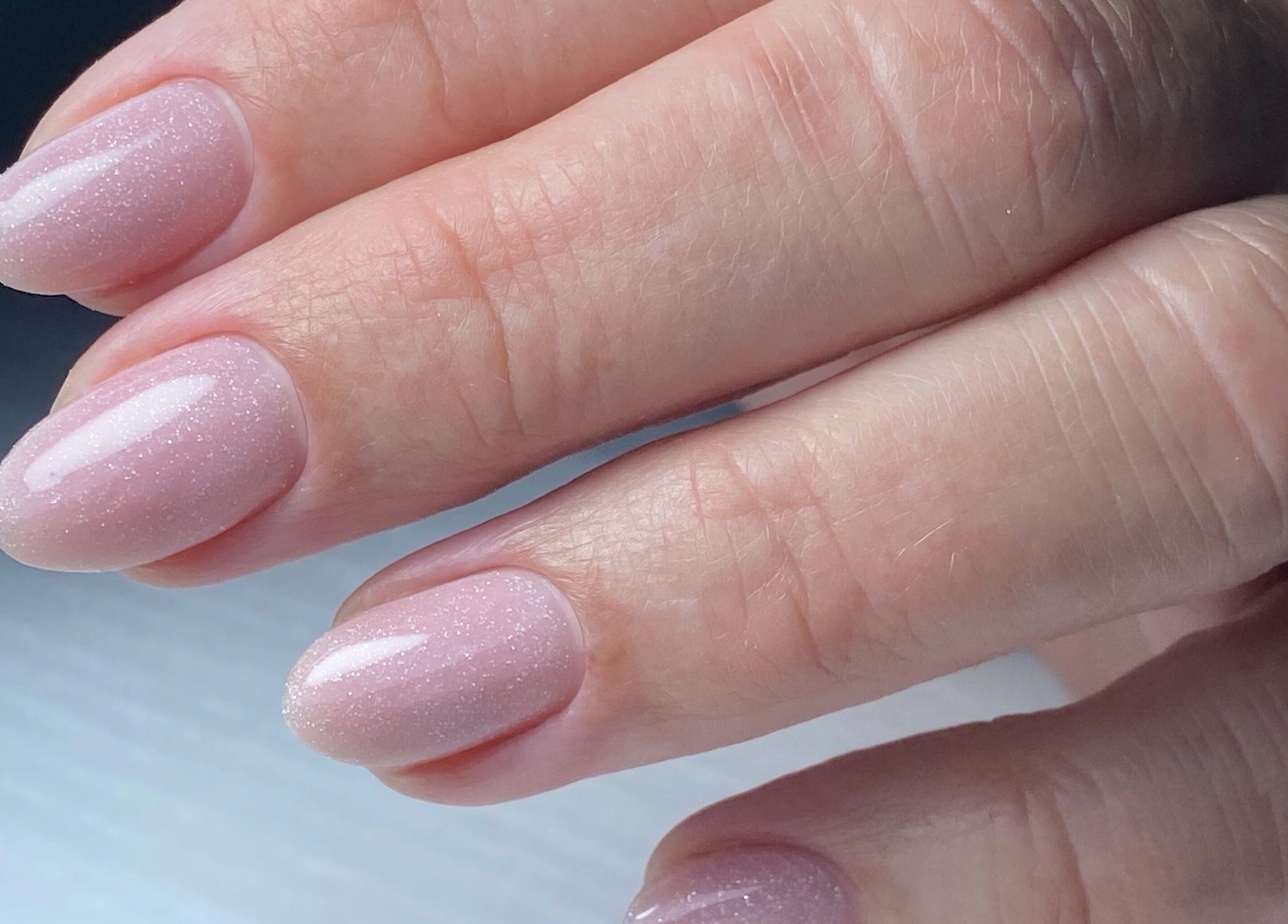 Close-up of glossy, pink manicured nails at My Balance Nail Studio, Thornhill, Ontario, CA.