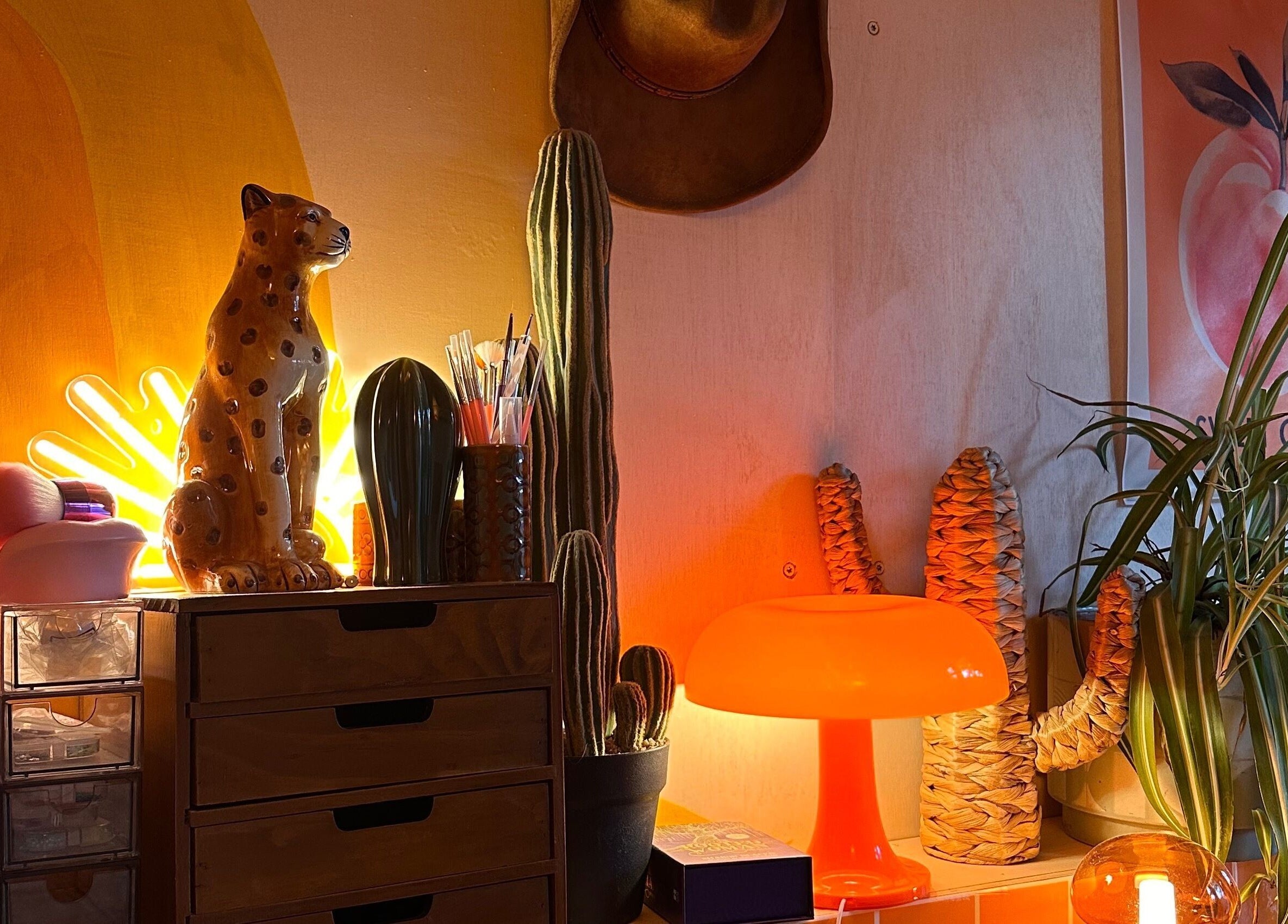 Eclectic decor at Emily Gossip Nails in Winscombe, England featuring bright neon lights and plants.