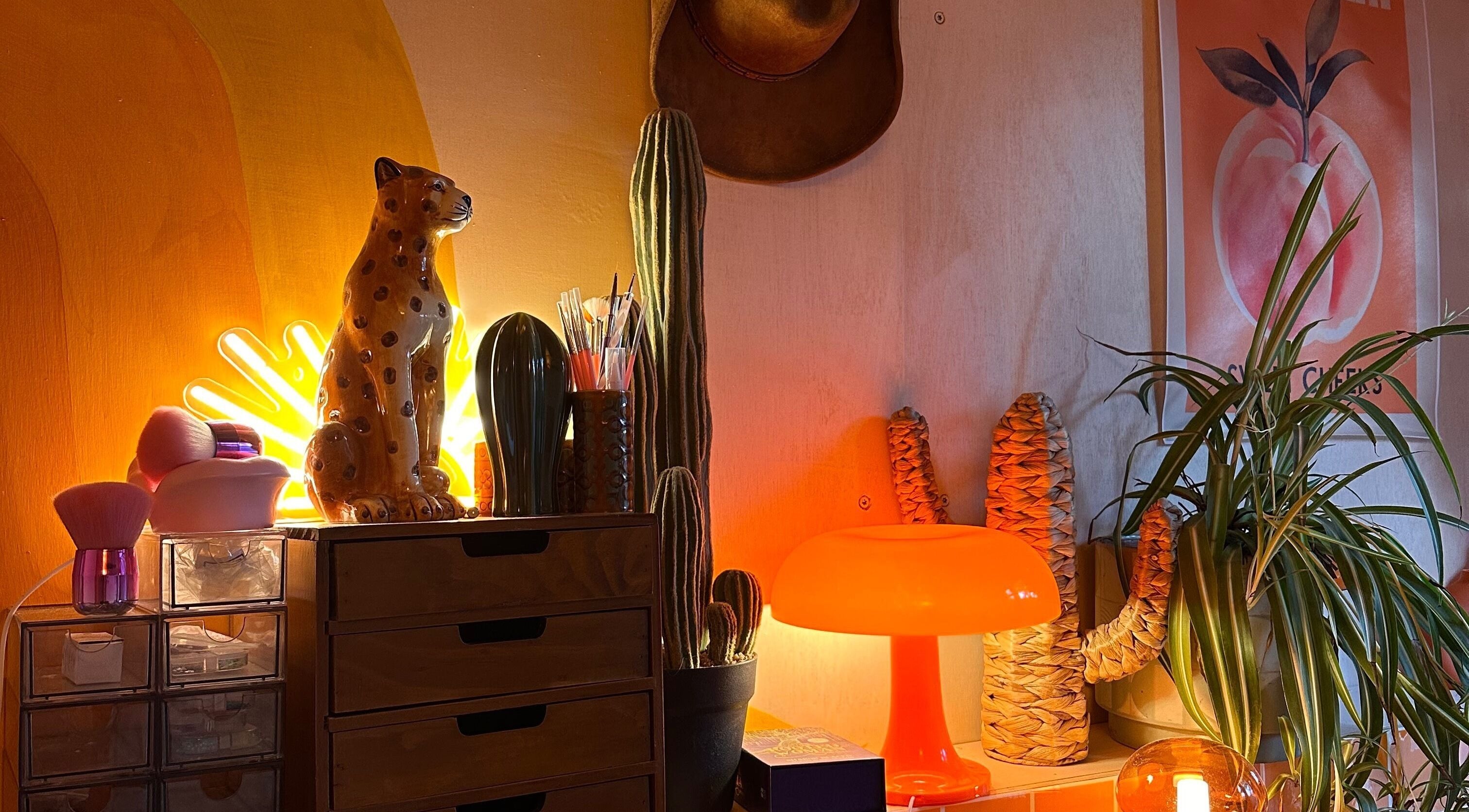 Eclectic decor at Emily Gossip Nails in Winscombe, England featuring bright neon lights and plants.