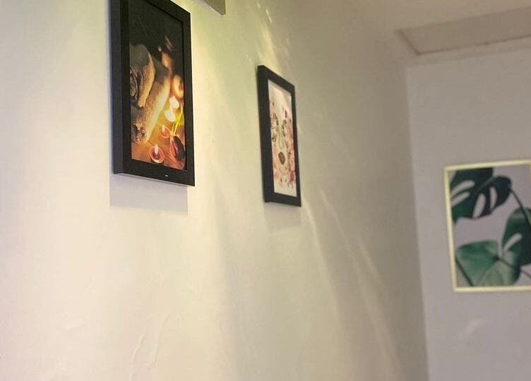 Art-adorned corridor at Moglow Beauty Spa, Abuja, Federal Capital Territory, NG, showcasing tranquil decor.