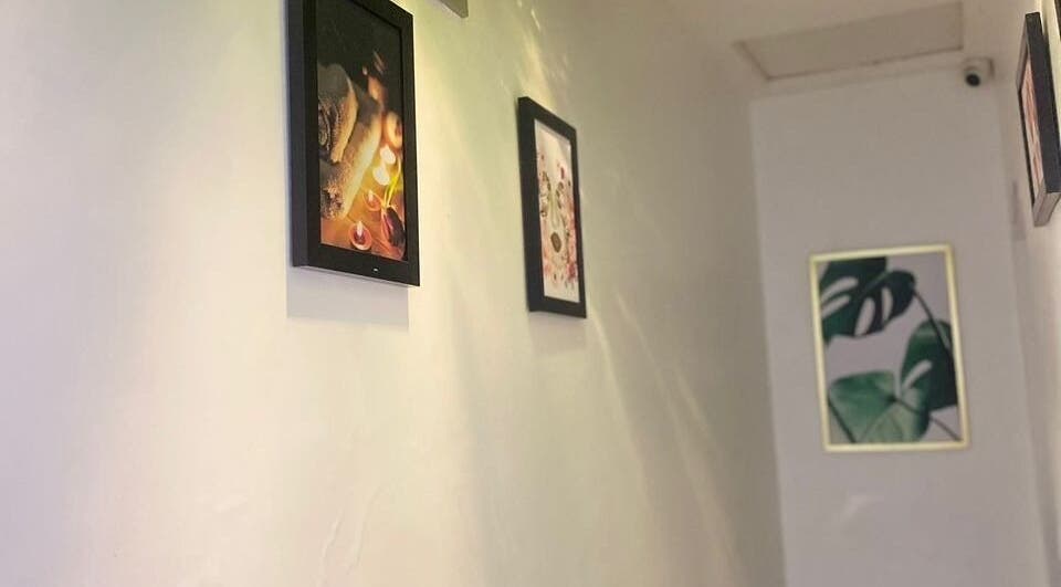 Art-adorned corridor at Moglow Beauty Spa, Abuja, Federal Capital Territory, NG, showcasing tranquil decor.