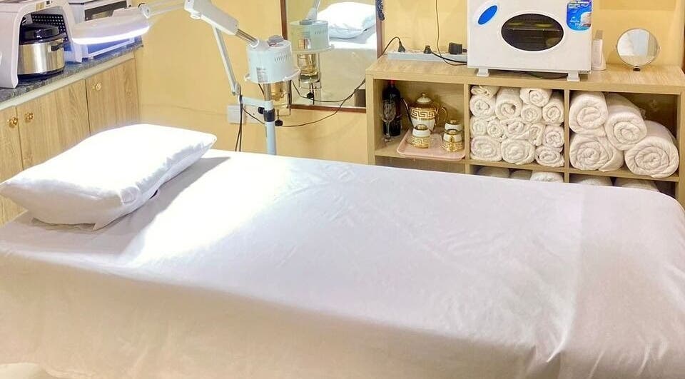 Relaxing spa room at Moglow Beauty Spa, Abuja, Federal Capital Territory, NG with massage bed and warm lighting.