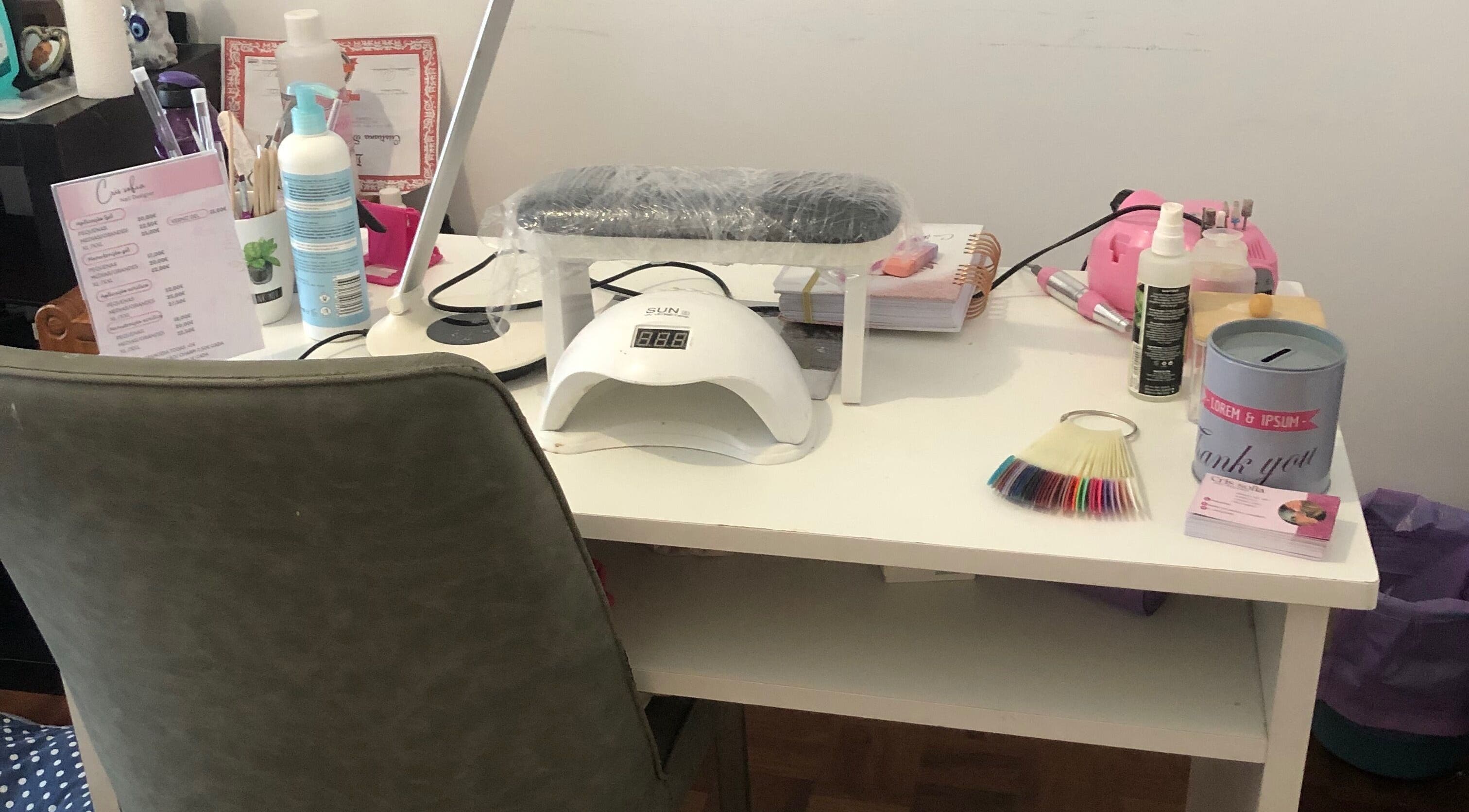 Nail care setup at Nails cris in Camarate, Lisboa, PT showcasing modern tools and colorful polish samples.