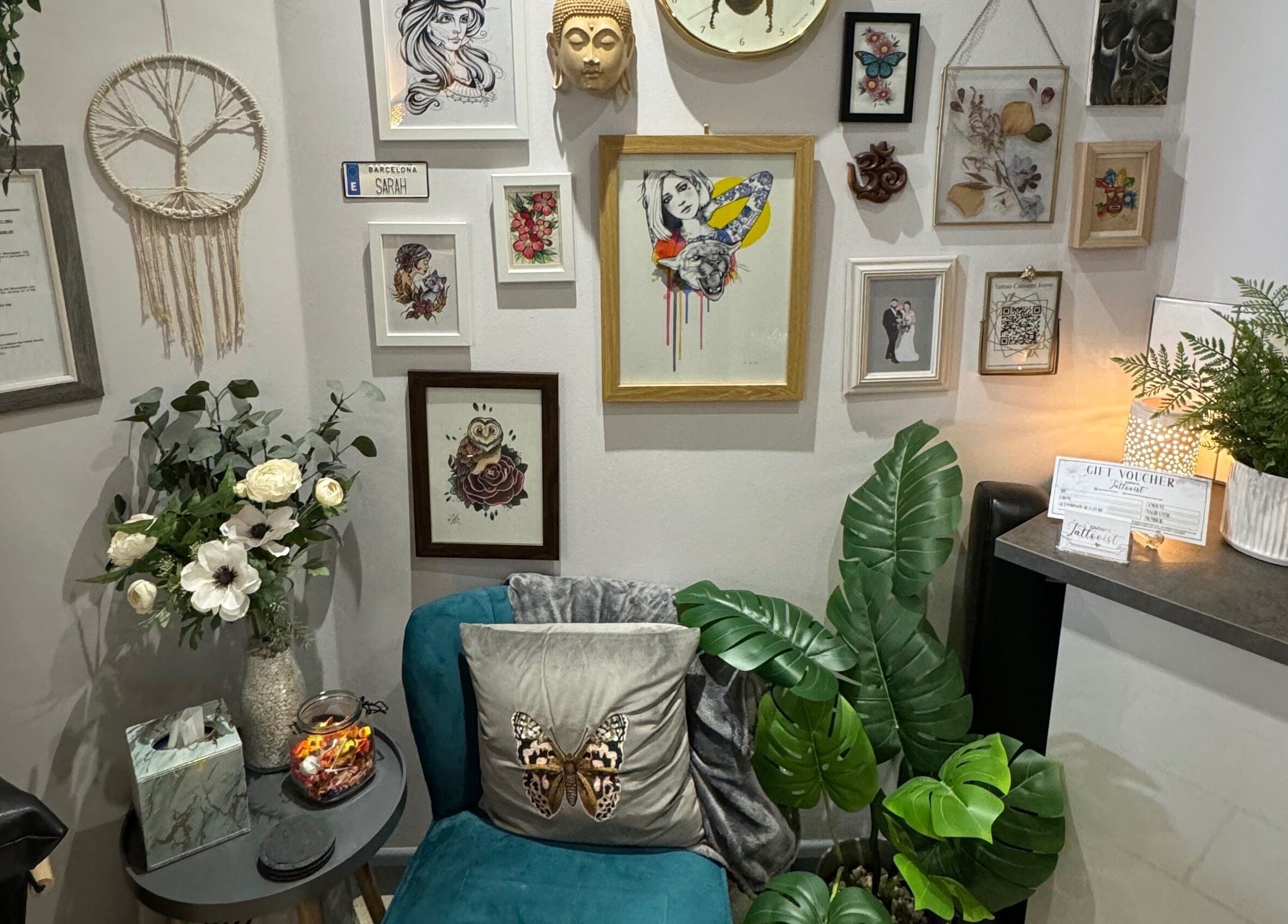 Sarah K Tattooist's artistic wall display in Birmingham, England, GB enhances the cozy wellness atmosphere.