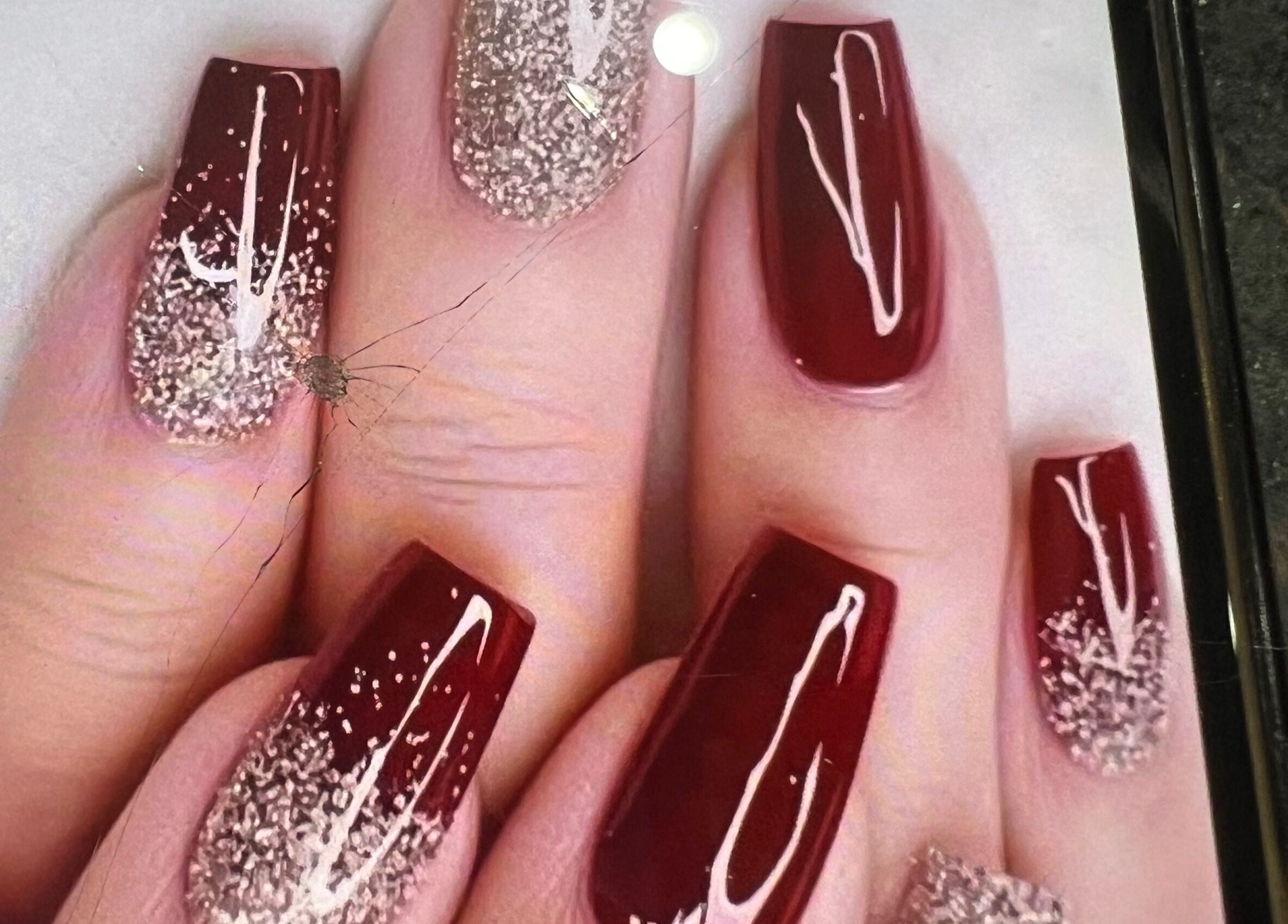 Crimson nails with glitter design at Shellac nail & spa, Oklahoma City, Oklahoma, US.