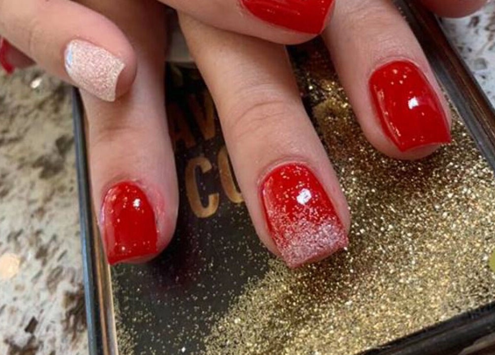 Stylish red shellac manicure with glitter at Shellac nail & spa, Oklahoma City, Oklahoma, US.