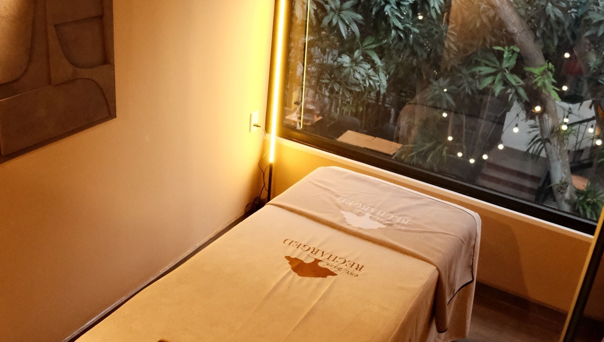 Relaxing massage room at Recharged SPA in Đà Nẵng, Đà Nẵng, VN, with tranquil garden view.