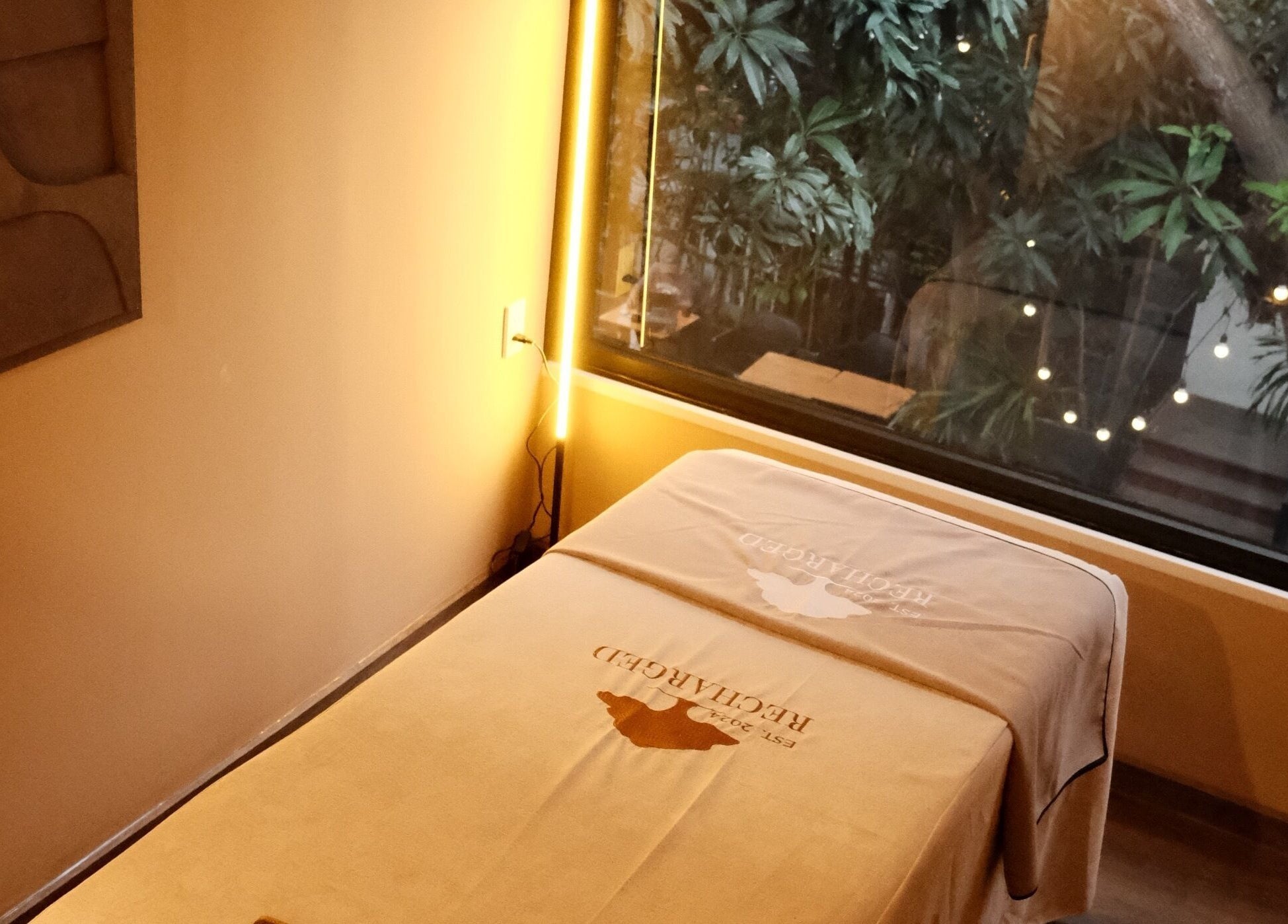 Relaxing massage room at Recharged SPA in Đà Nẵng, Đà Nẵng, VN, with tranquil garden view.