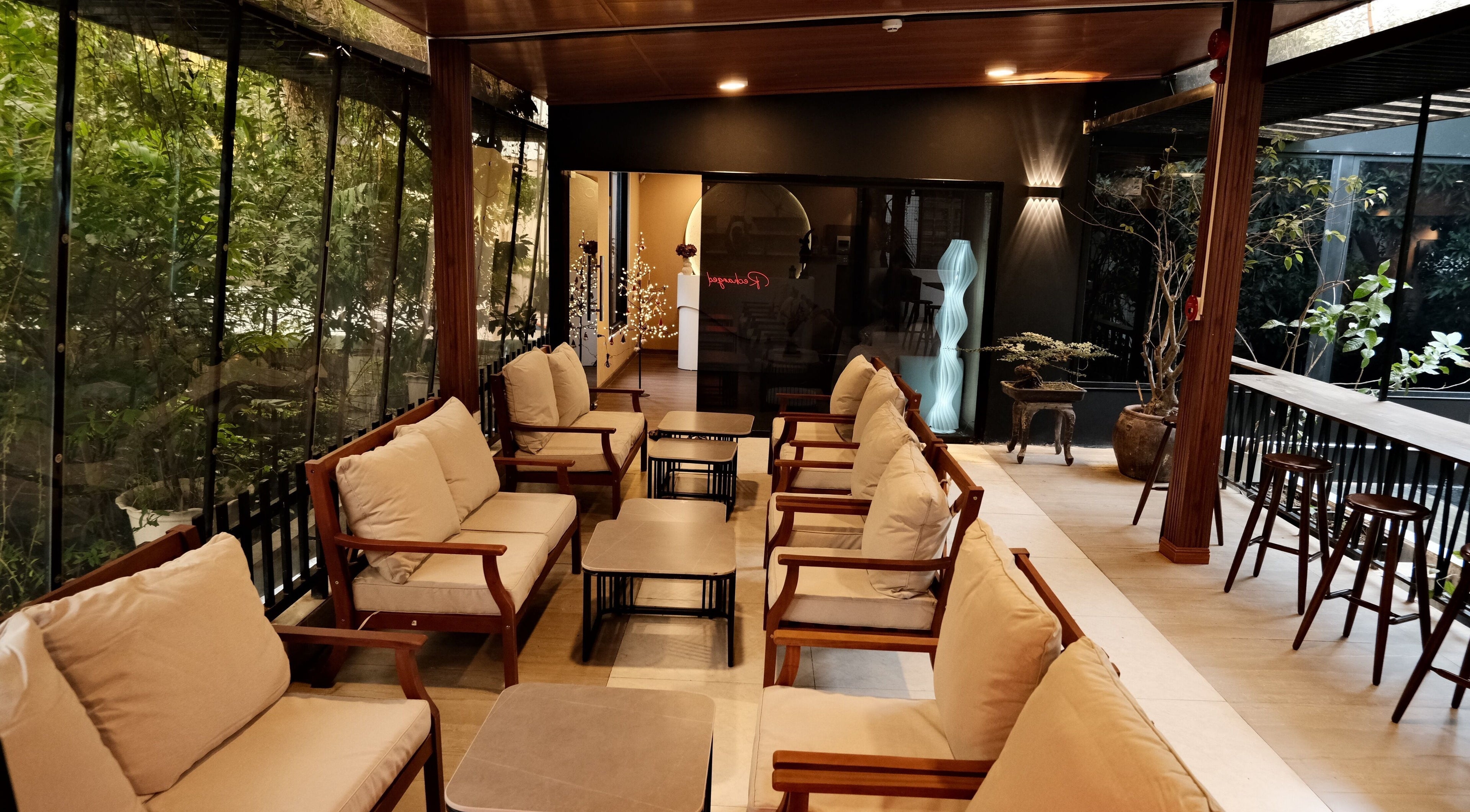 Relaxing seating area at Recharged SPA in Đà Nẵng, Đà Nẵng, VN, surrounded by lush greenery.