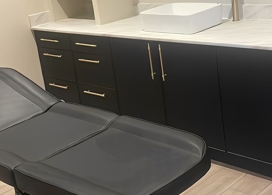 Modern treatment room at Ziba Beauty Lounge in Portsmouth, England, GB with stylish black furniture.