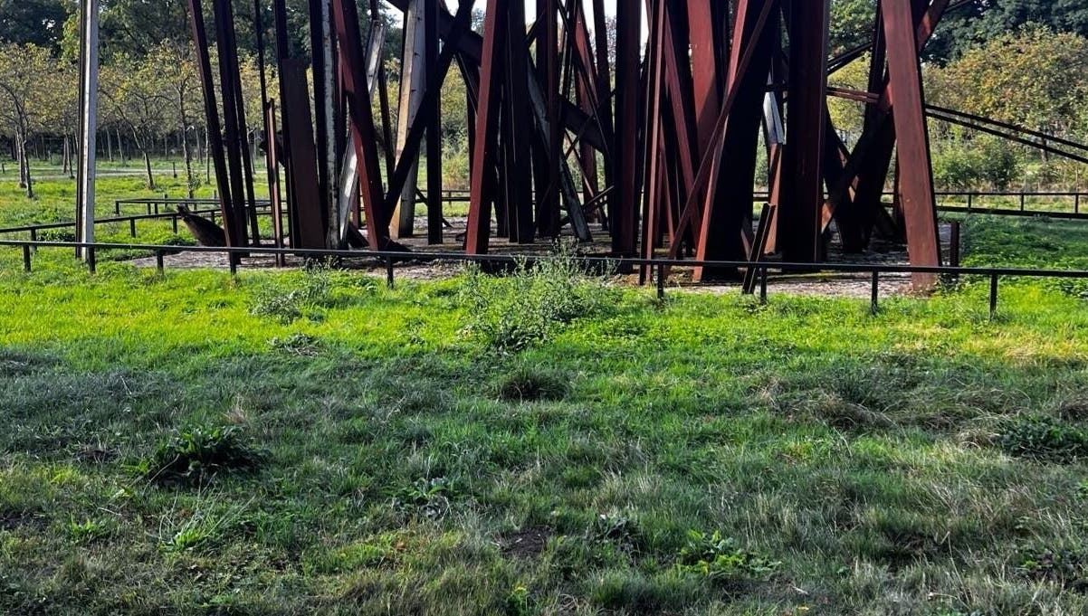 Artful steel structure in a green park at barbershop, Genk, Vlaanderen, BE.