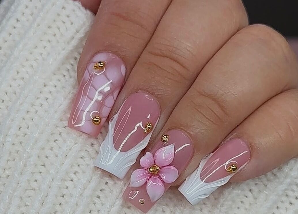 Elegant floral nail art at Queen Nails Northfield Spa in Birmingham, England, GB, with pink and white accents.