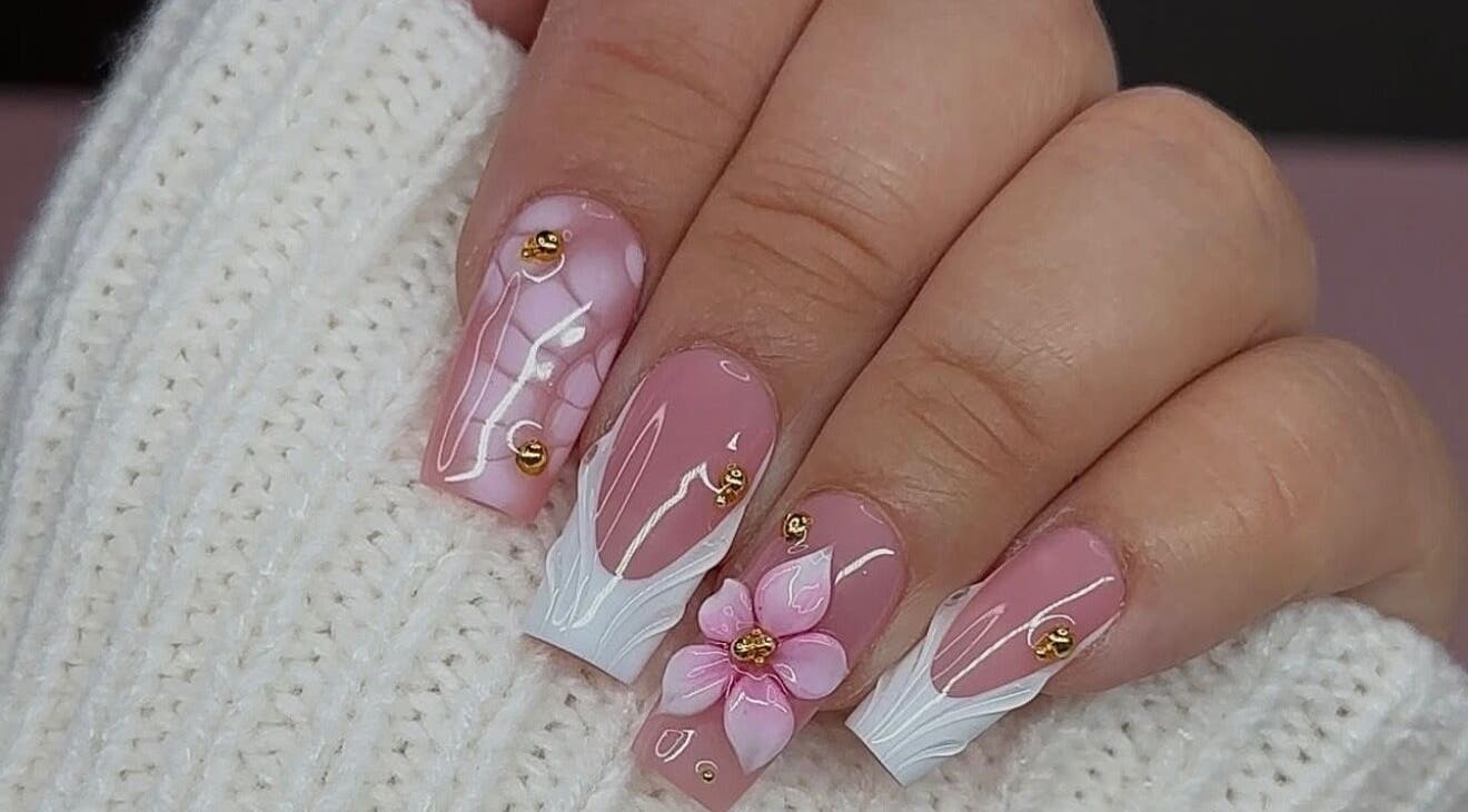 Elegant floral nail art at Queen Nails Northfield Spa in Birmingham, England, GB, with pink and white accents.