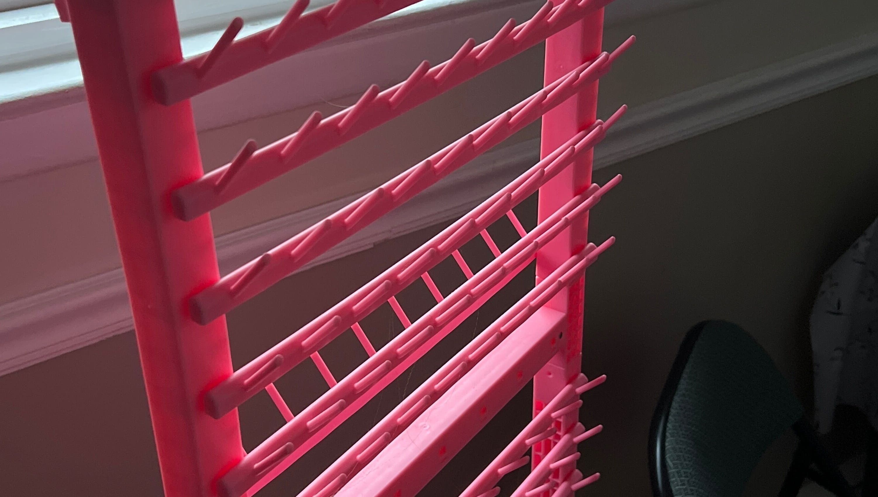 Pink nail polish rack at Styled By Lexa, West New York, New Jersey, US, showcasing vibrant organization.