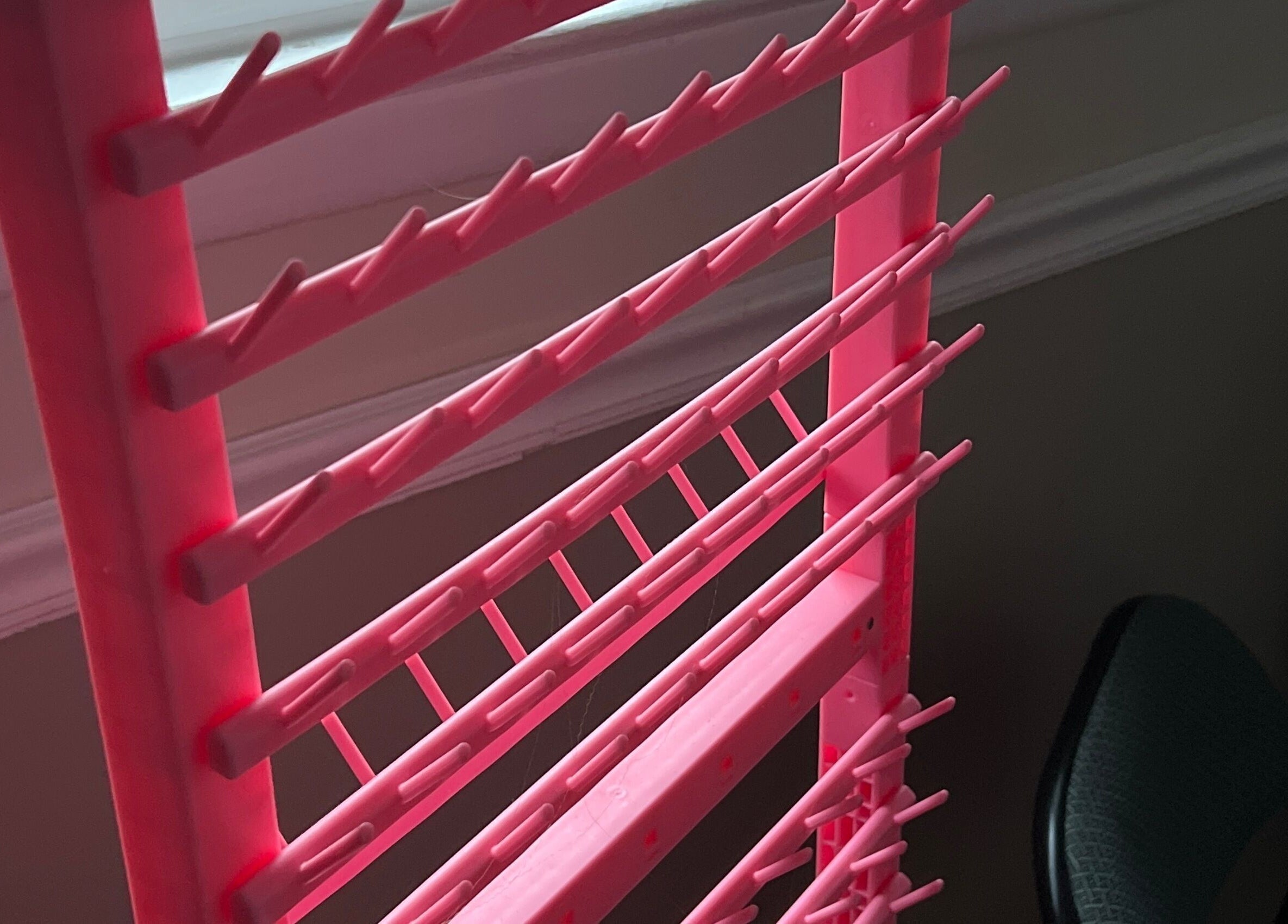 Pink nail polish rack at Styled By Lexa, West New York, New Jersey, US, showcasing vibrant organization.