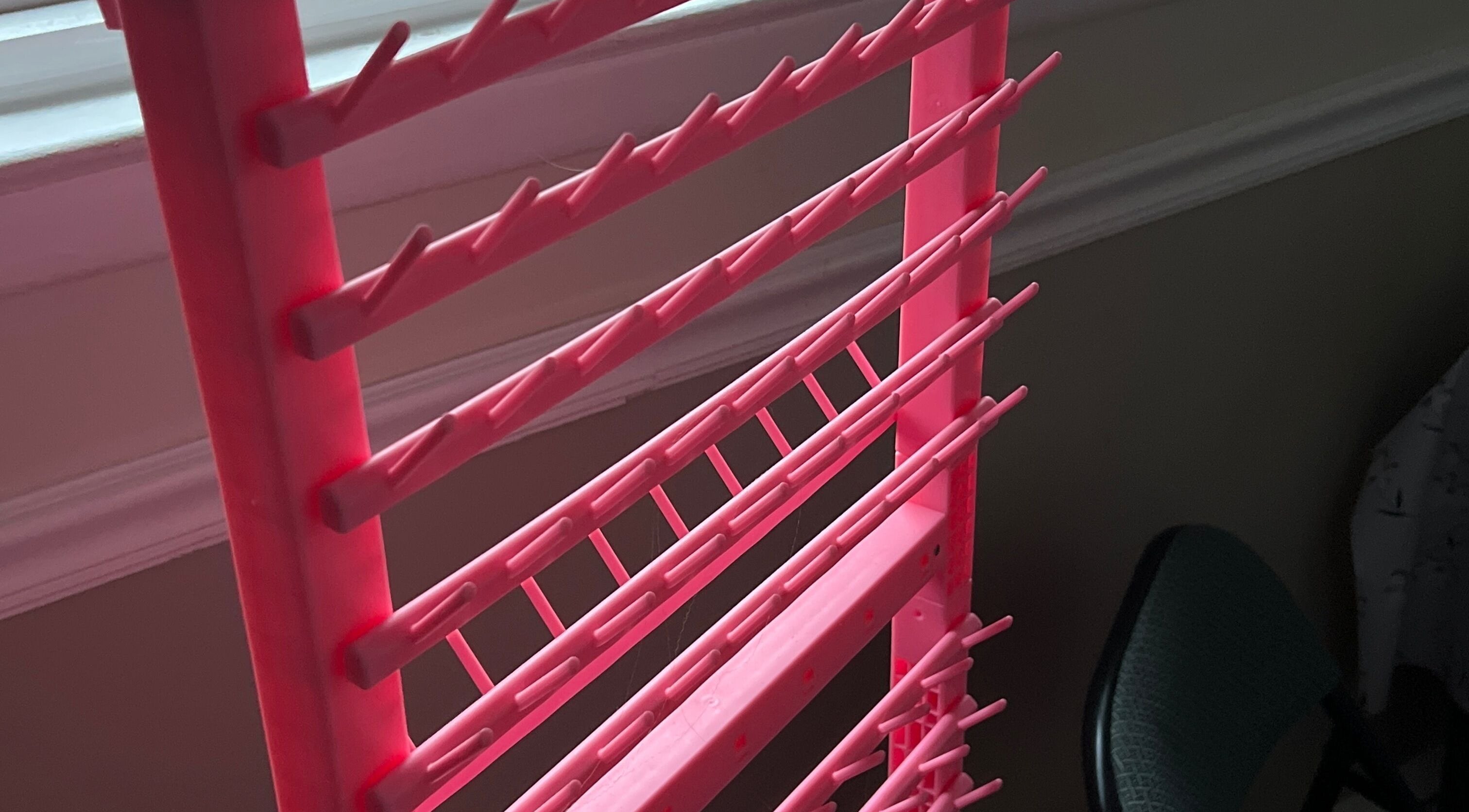 Pink nail polish rack at Styled By Lexa, West New York, New Jersey, US, showcasing vibrant organization.