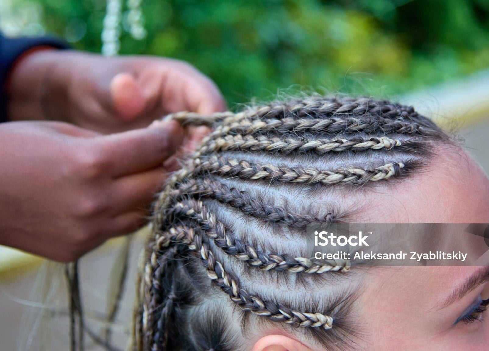 Close-up of braiding at Dan hair style, Birmingham, England, GB showcasing expert hairstyling.