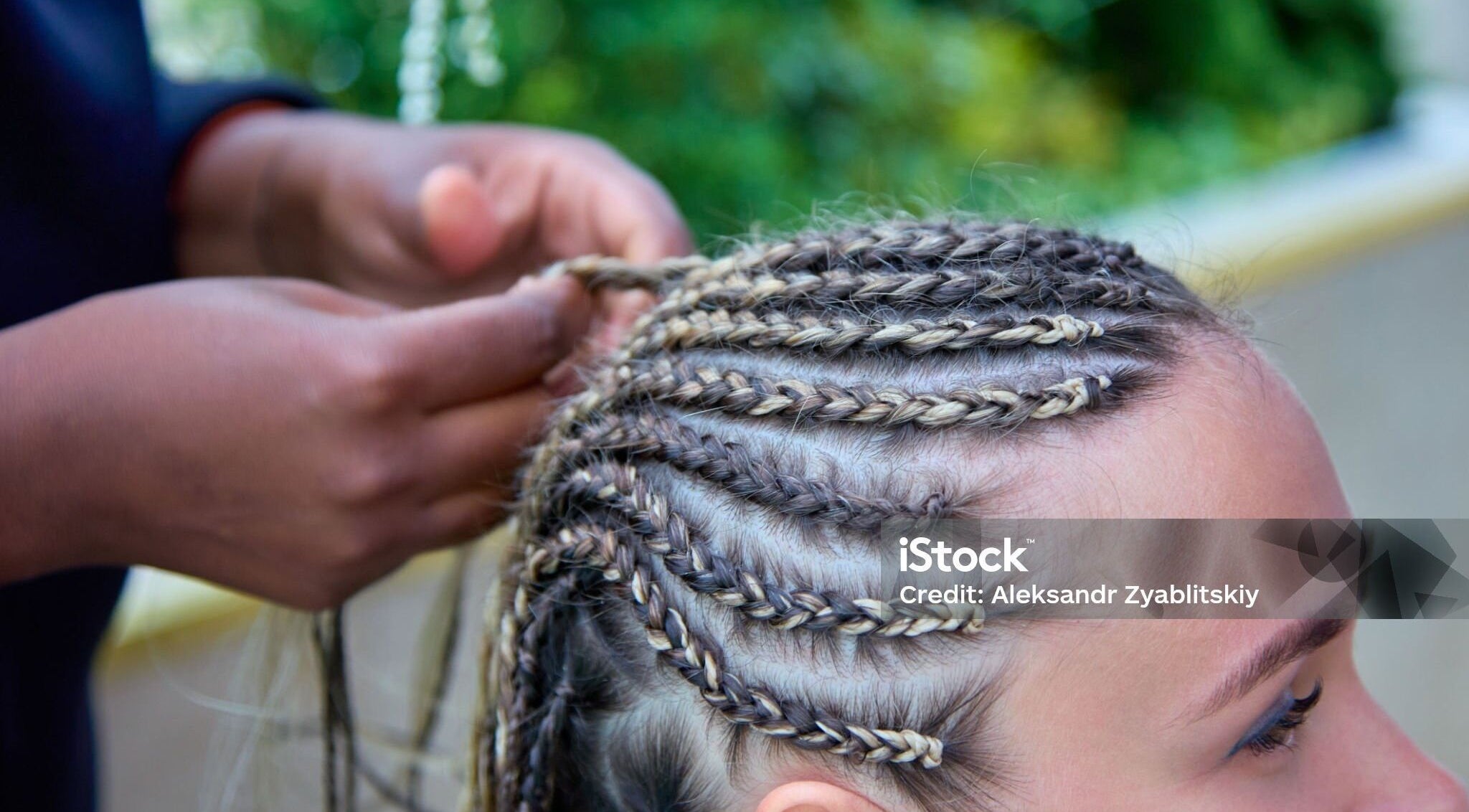 Close-up of braiding at Dan hair style, Birmingham, England, GB showcasing expert hairstyling.