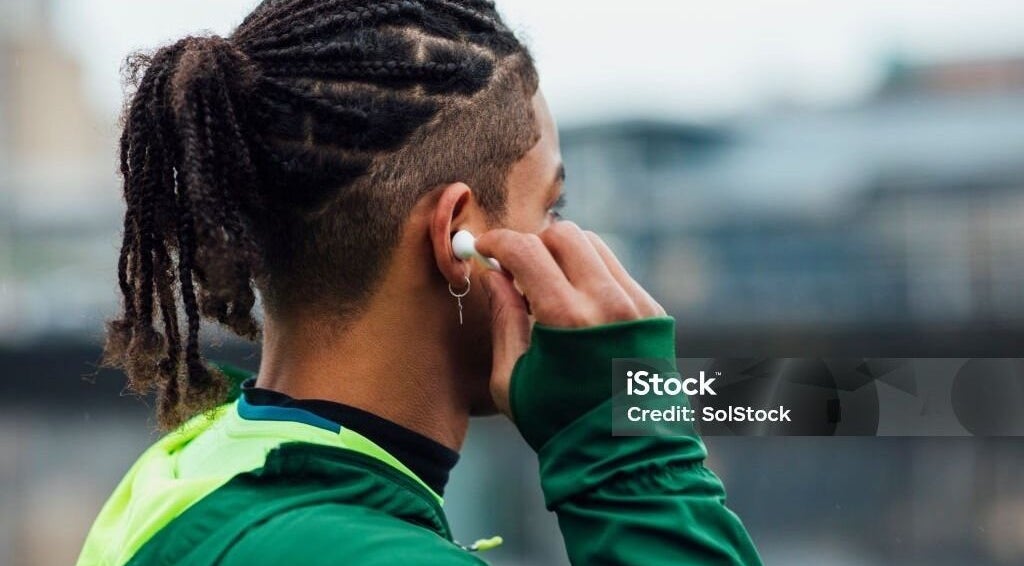 Man with stylish braids at Dan Hair Style, Birmingham, England, GB.