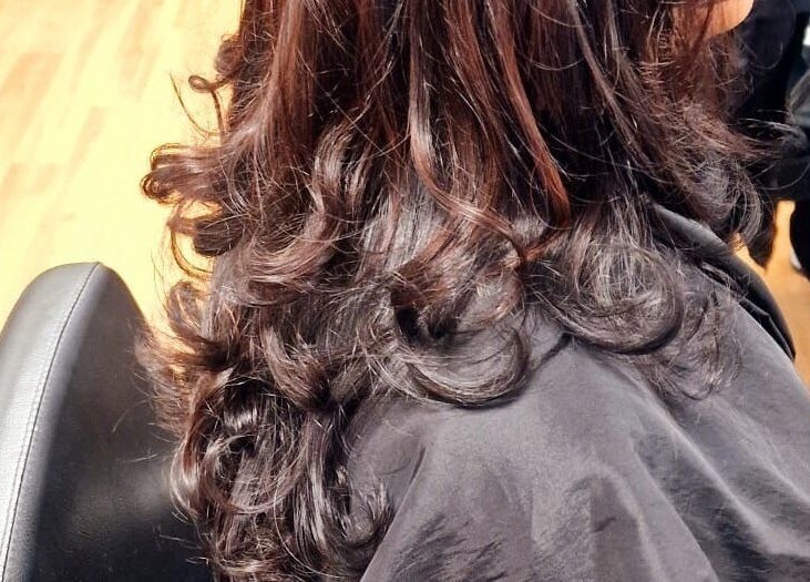 Stylish curled hairstyle at Dan Hair Style in Birmingham, England, GB.