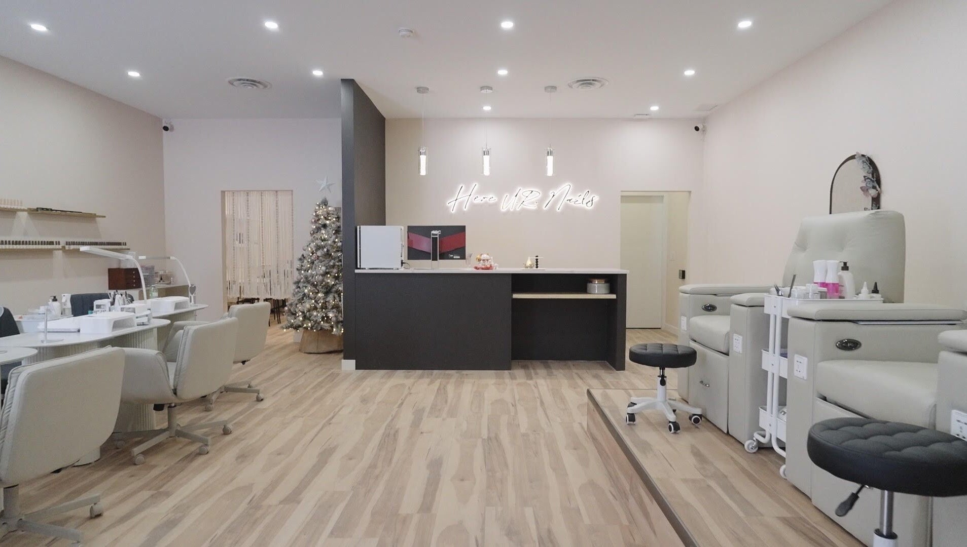 Modern interior of HERE U. R. NAILS salon in Winnipeg, Manitoba, CA showcasing stylish manicure stations.