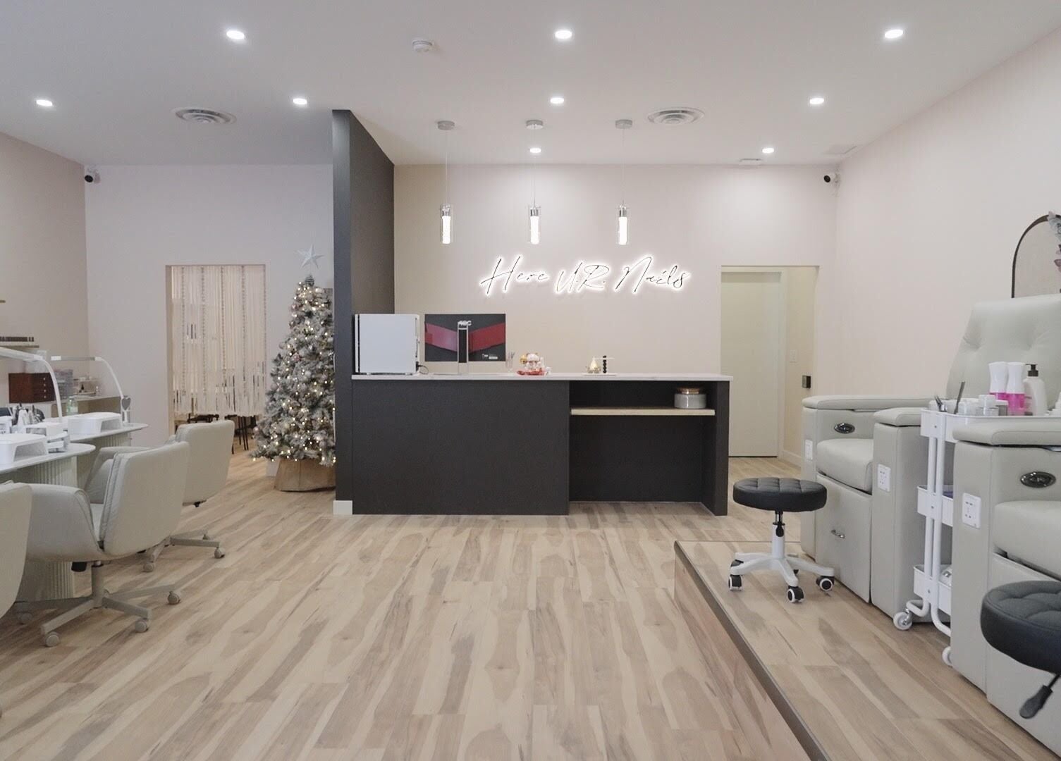 Modern interior of HERE U. R. NAILS salon in Winnipeg, Manitoba, CA showcasing stylish manicure stations.