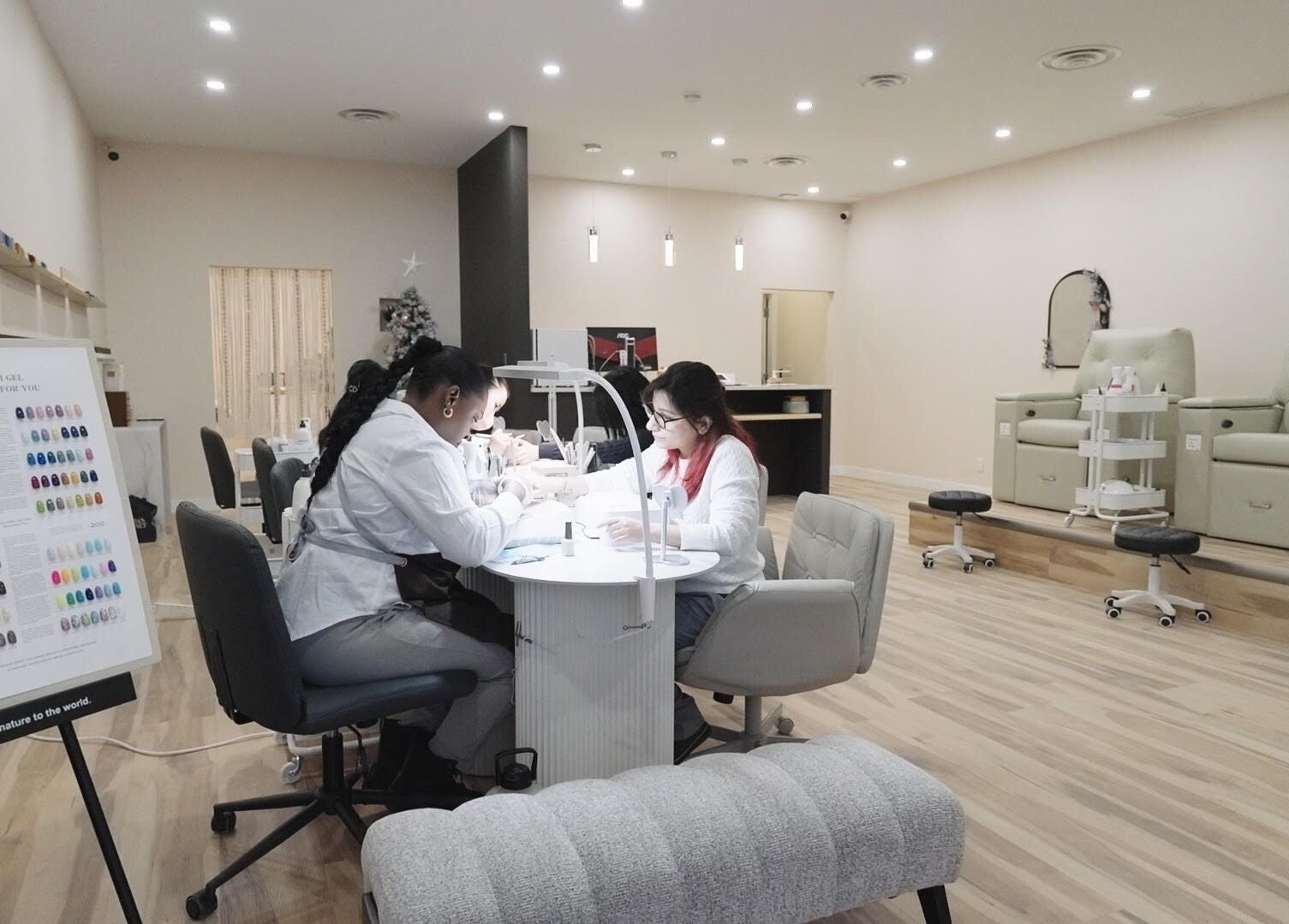 Modern interior of HERE U. R. NAILS, Winnipeg, Manitoba, CA showcasing nail technicians at work.