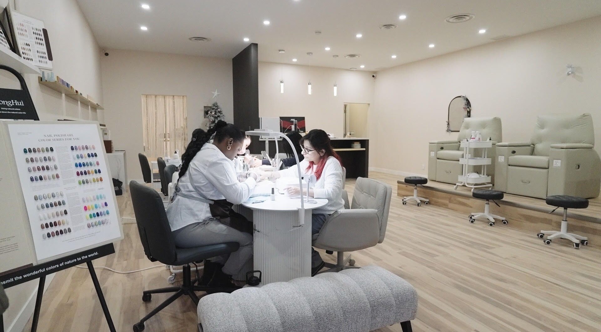 Modern interior of HERE U. R. NAILS, Winnipeg, Manitoba, CA showcasing nail technicians at work.