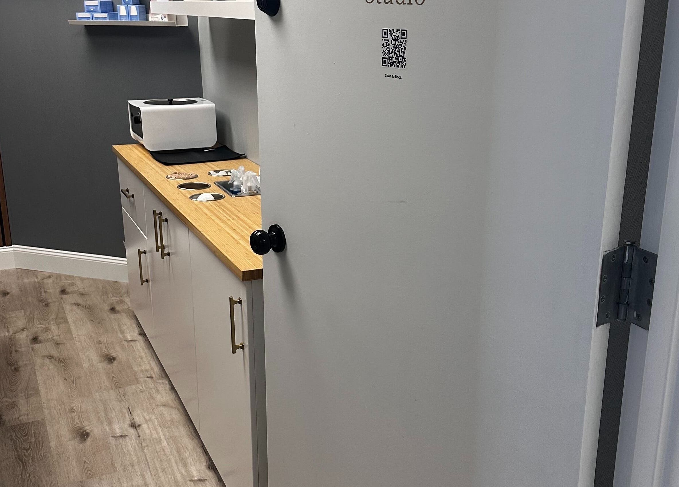 Cozy waxing room at Pro Wax Studio in Oradell, New Jersey, US with modern decor and warm ambiance.