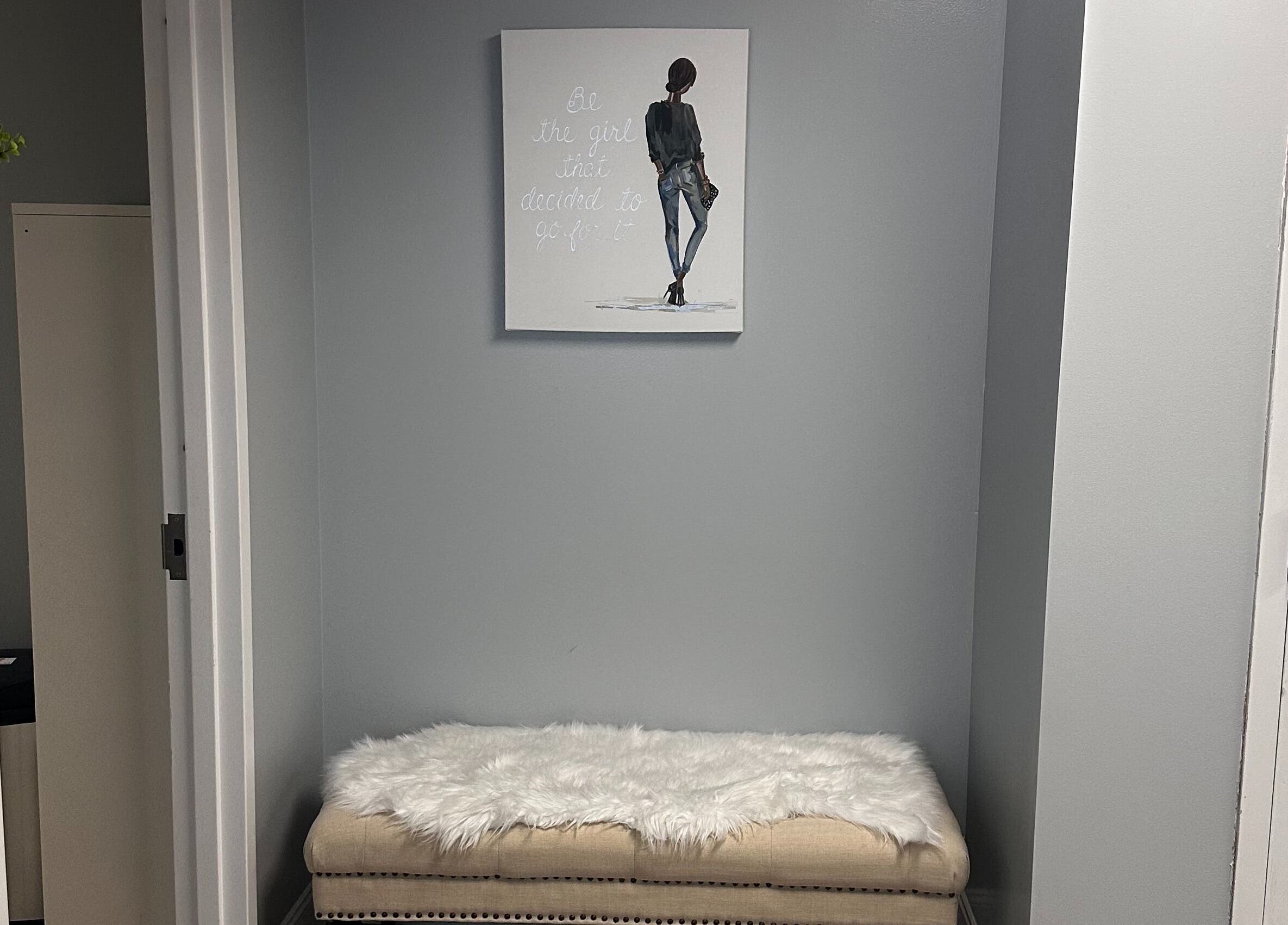 Chic waiting area at Pro Wax Studio, Oradell, New Jersey, US with art and plush seating.