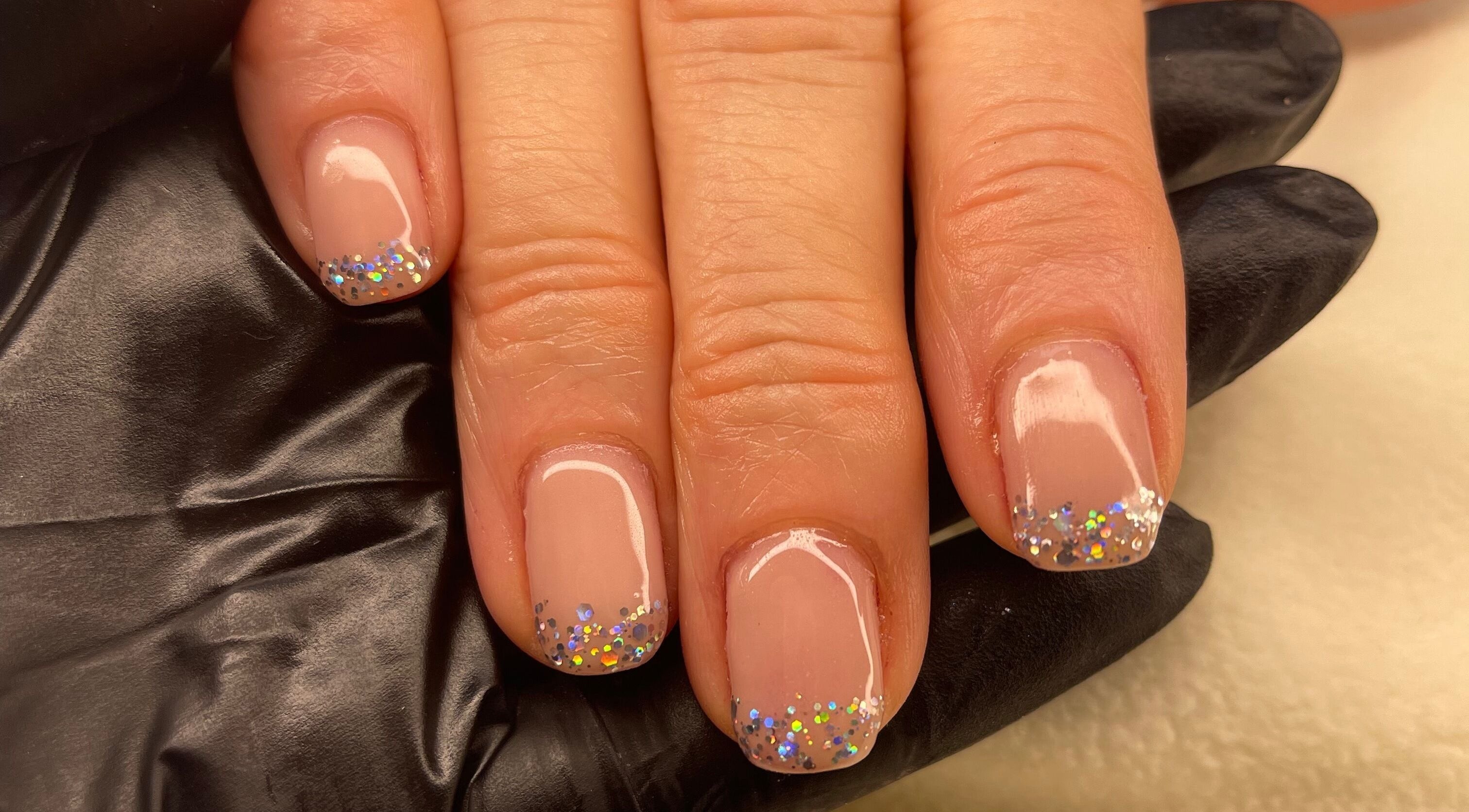 Glittery nail art at Coco’s Beauty in Clanfield, England, GB.