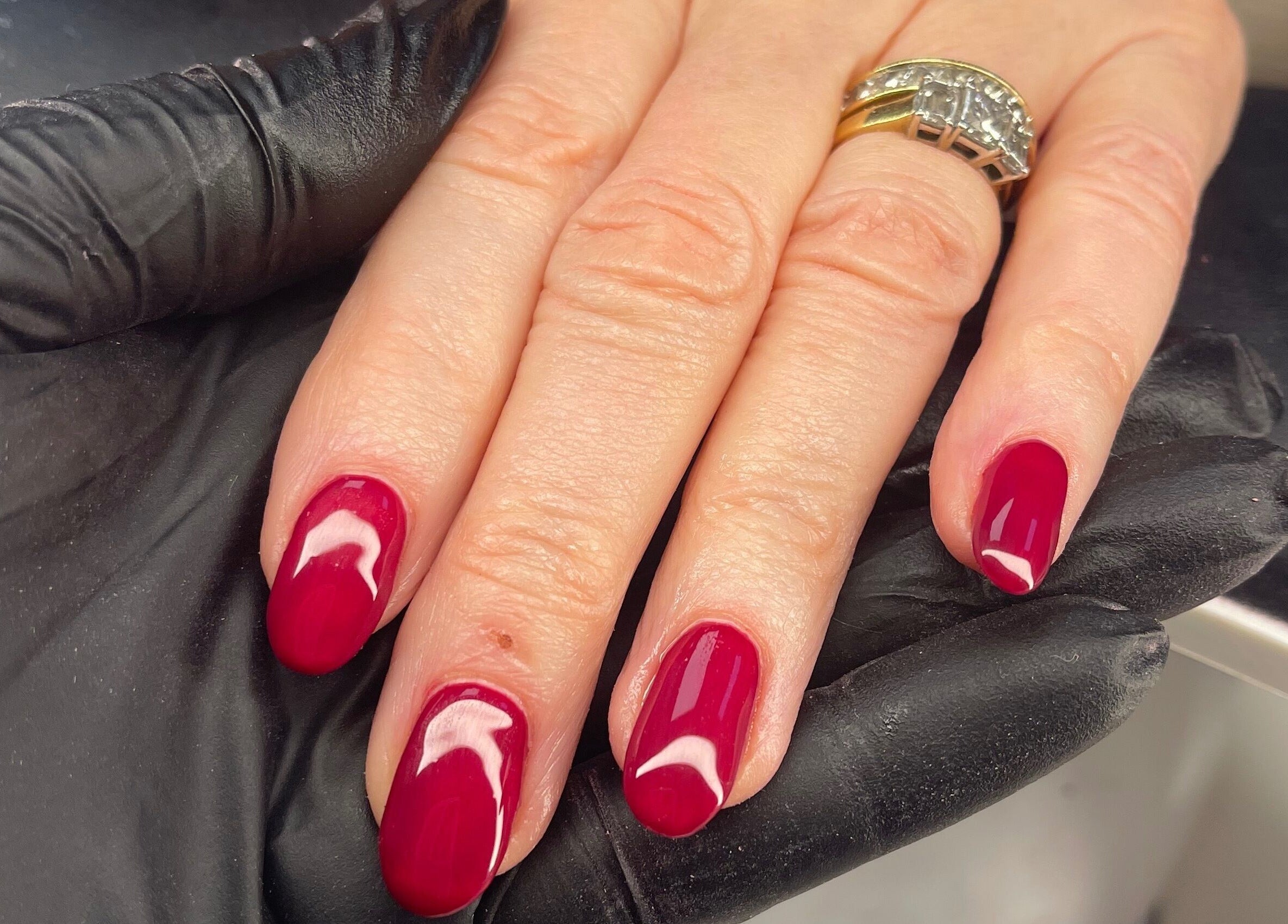 Close-up of red manicured nails at Coco’s Beauty in Clanfield, England, GB.