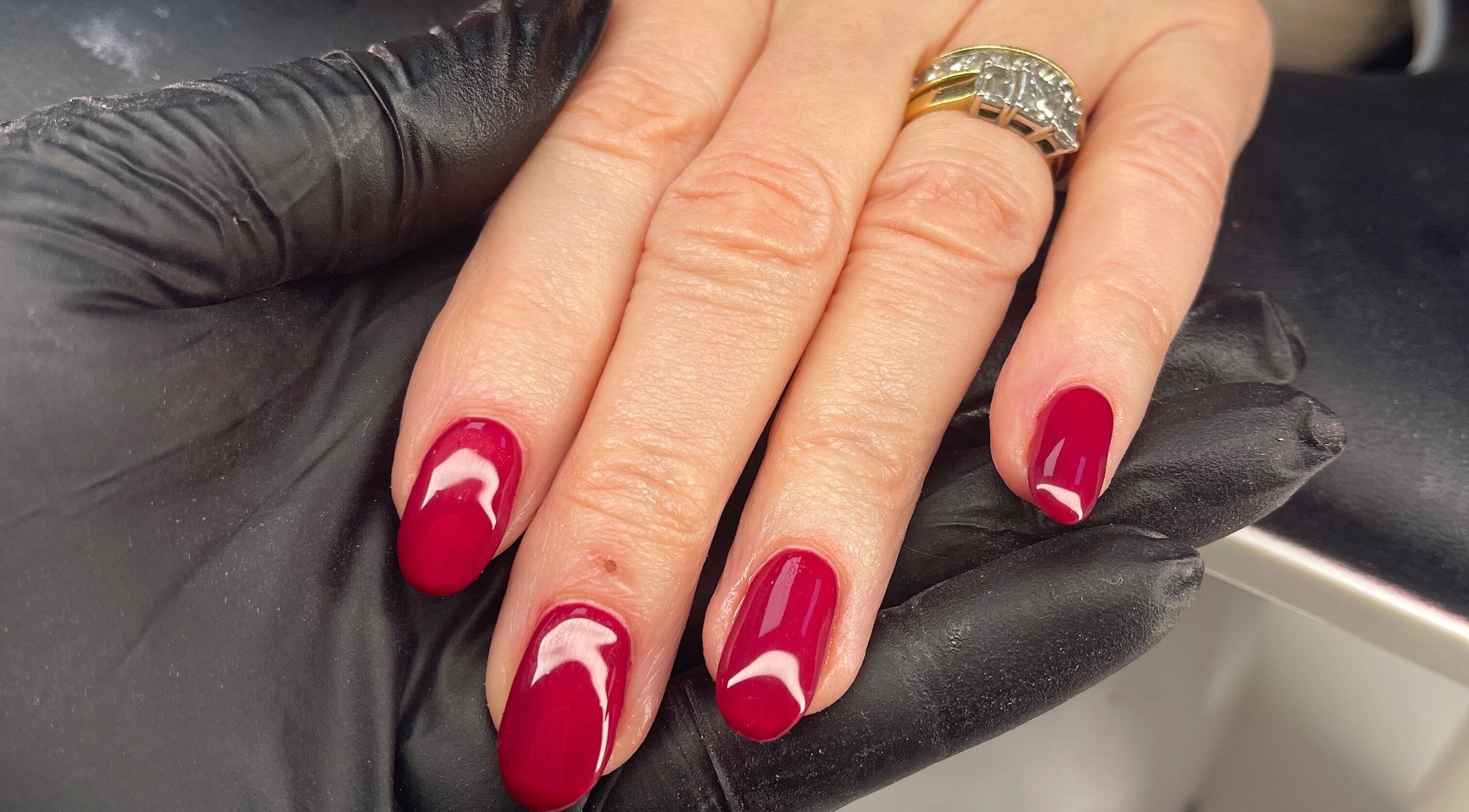 Close-up of red manicured nails at Coco’s Beauty in Clanfield, England, GB.