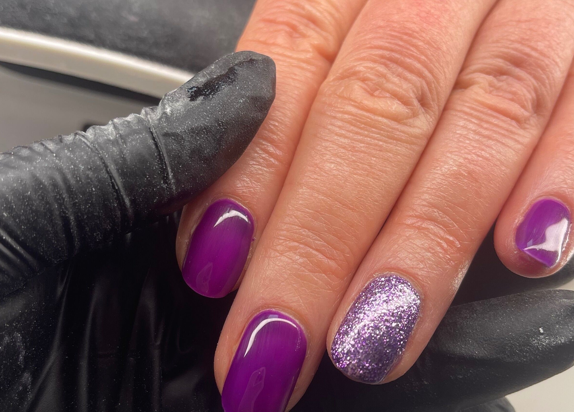 Purple and glitter nails manicure at Coco’s Beauty, Clanfield, England, GB.
