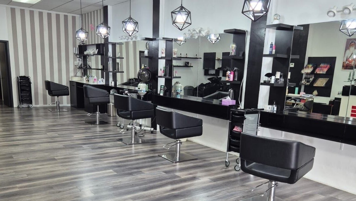 Interior of Luxe Hair & Beauty Salon in Hamilton, Waikato Region, NZ, featuring modern chairs and stylish lighting.