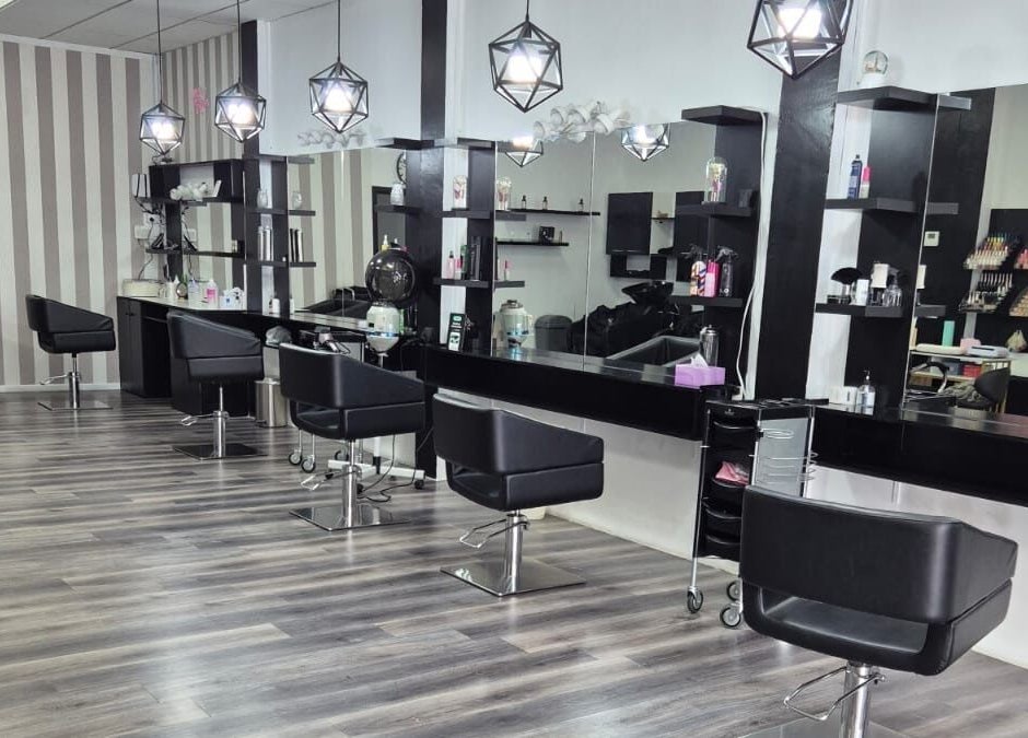 Interior of Luxe Hair & Beauty Salon in Hamilton, Waikato Region, NZ, featuring modern chairs and stylish lighting.