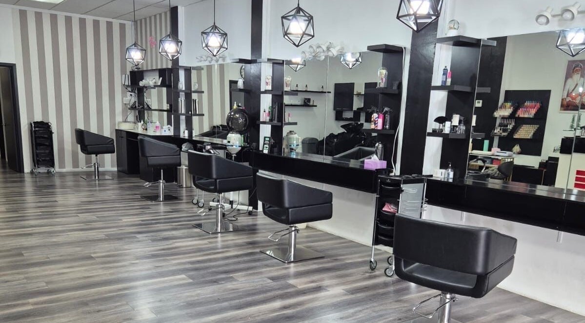 Interior of Luxe Hair & Beauty Salon in Hamilton, Waikato Region, NZ, featuring modern chairs and stylish lighting.