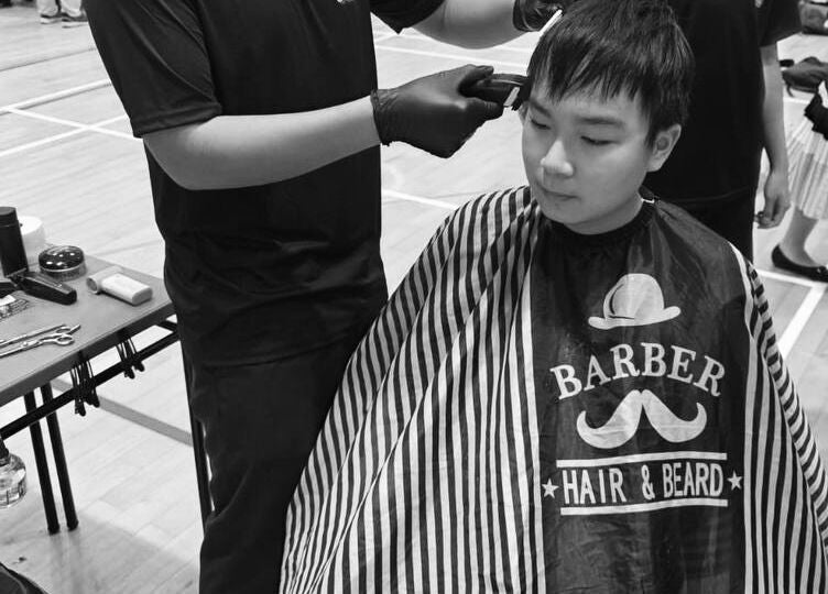 Haircut session at fanfadess, Singapore, SG. A barber trims hair with tools on a table.