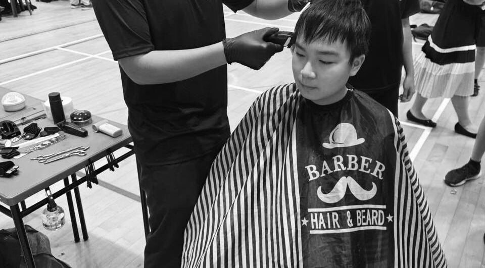 Haircut session at fanfadess, Singapore, SG. A barber trims hair with tools on a table.