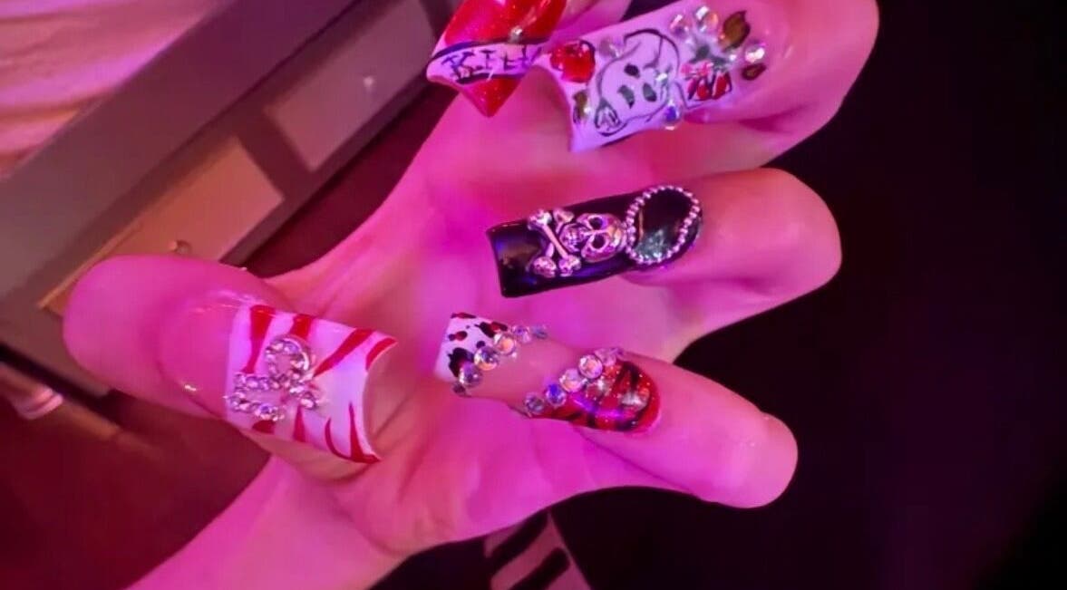 Bold nail art design from Kaicrylics in Port Charlotte, Florida, US with intricate embellishments.