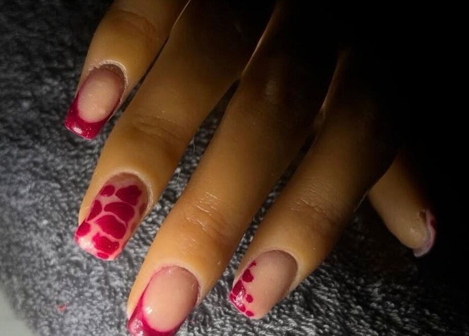 Elegant nail art with red design at Kaicrylics, Port Charlotte, Florida, US.