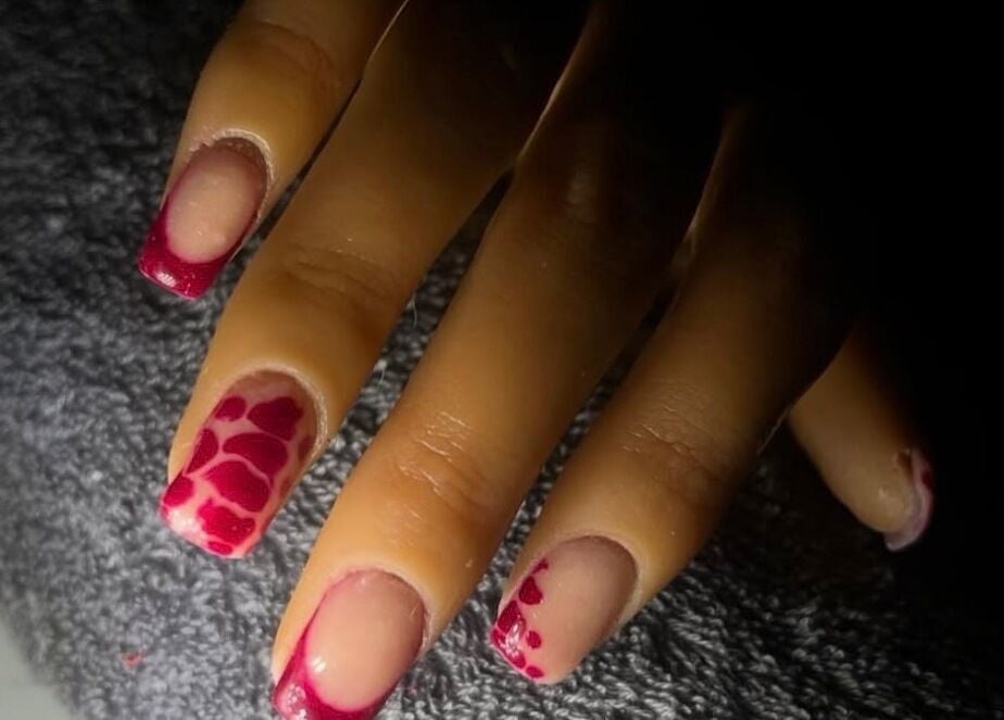 Elegant nail art with red design at Kaicrylics, Port Charlotte, Florida, US.