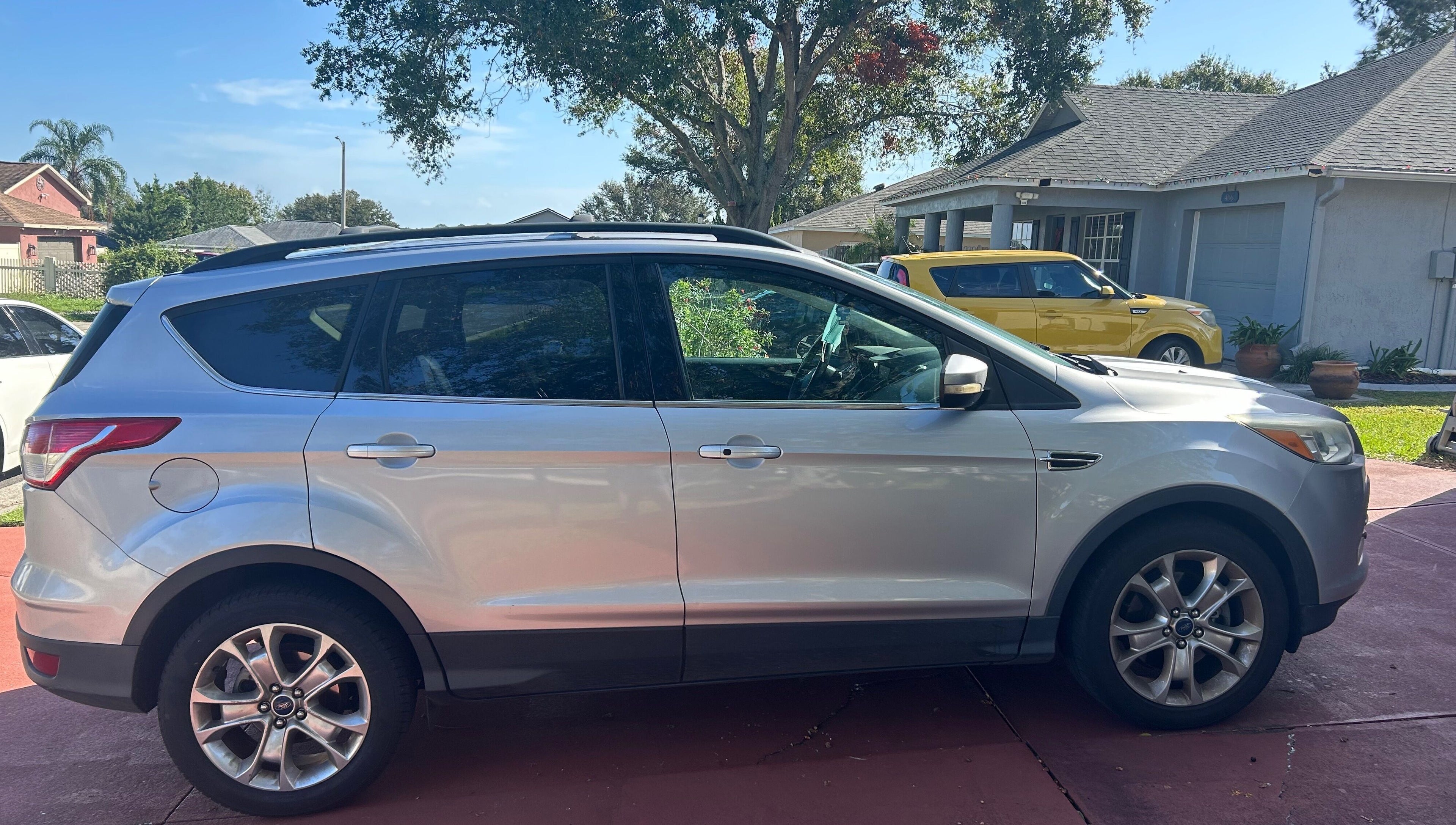 Silver SUV parked in driveway at Grant rentals, Auburndale, Florida, US under a sunny sky.
