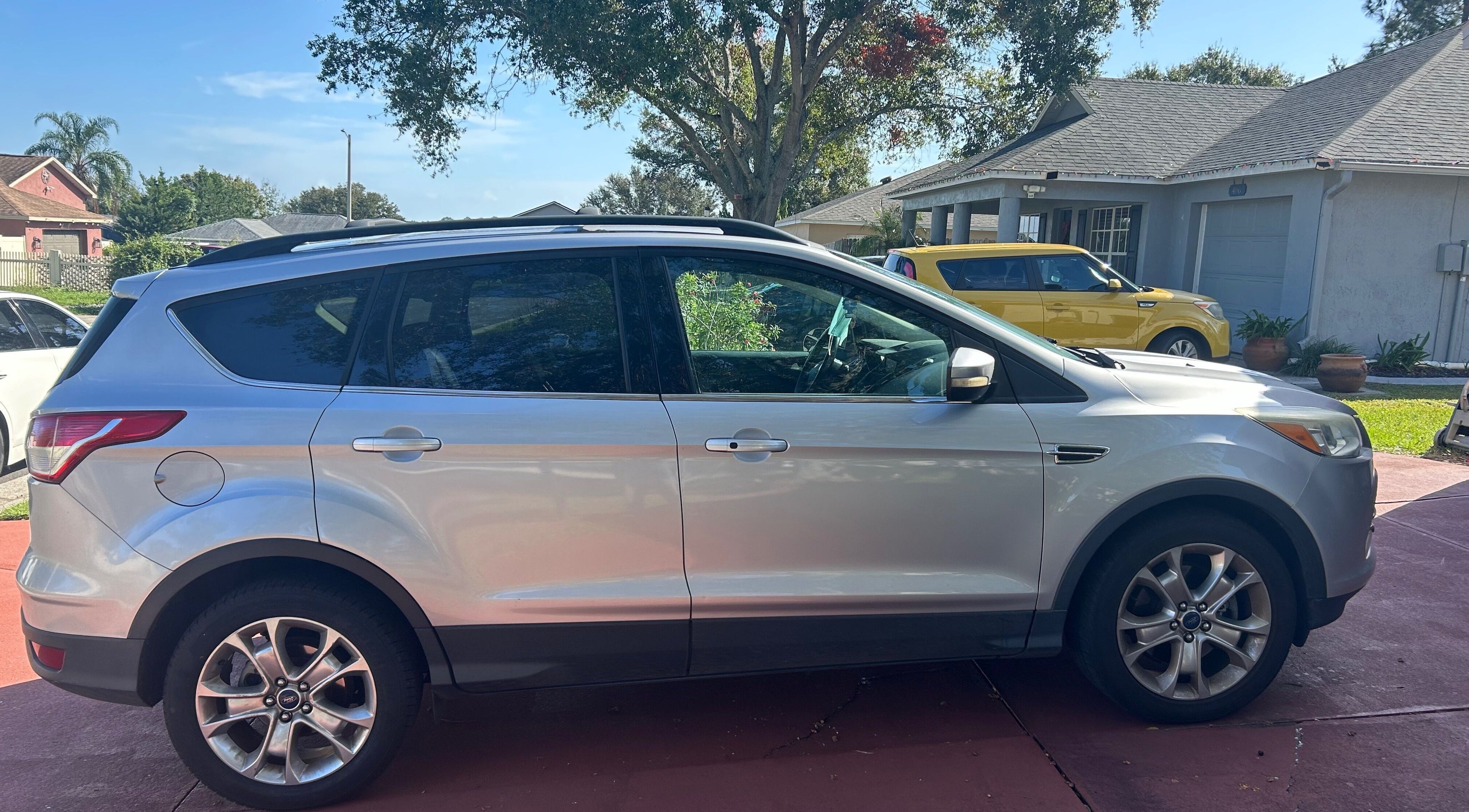 Silver SUV parked in driveway at Grant rentals, Auburndale, Florida, US under a sunny sky.