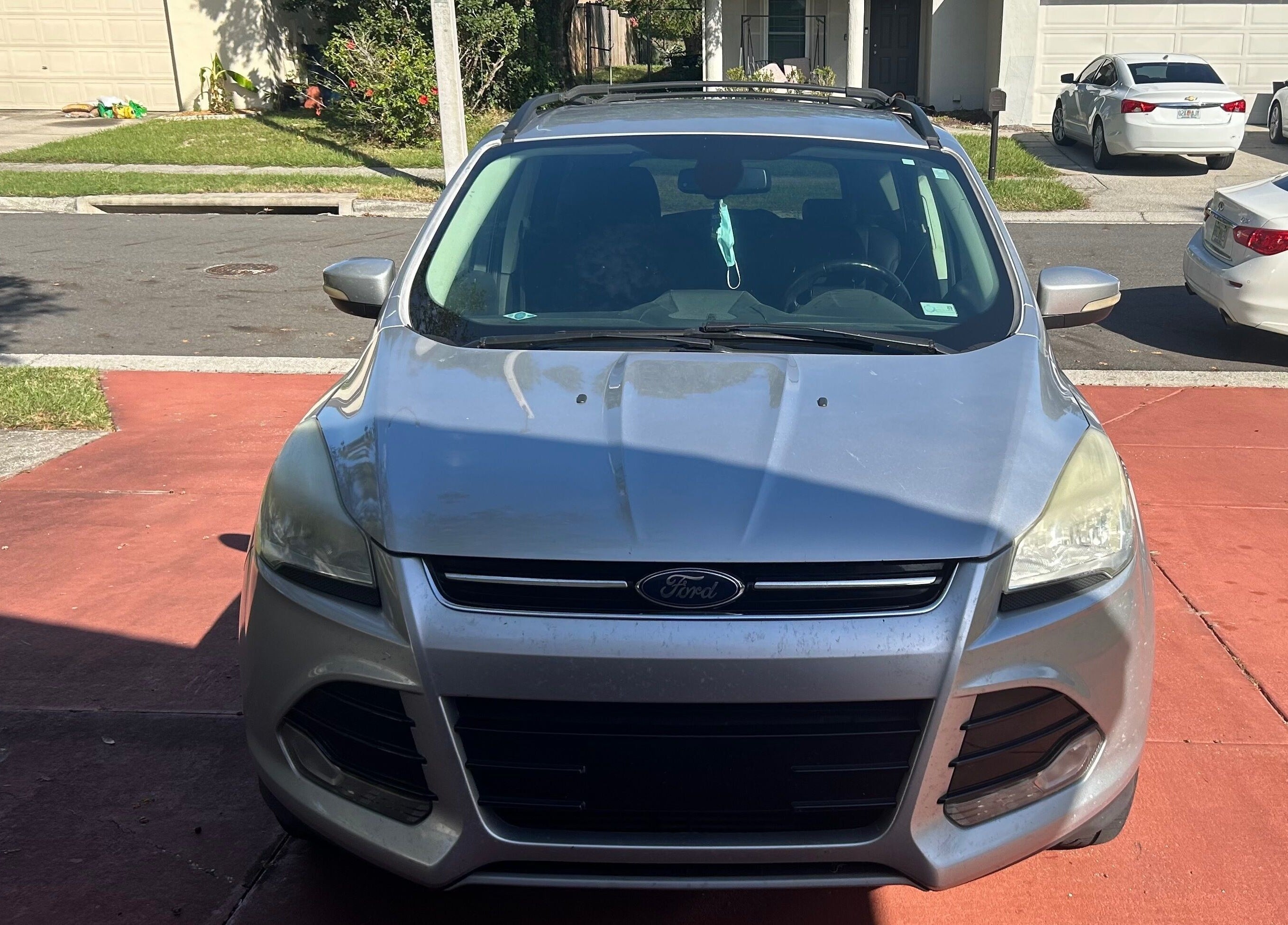 Car parked on a residential driveway near Grant rentals, Auburndale, Florida, US.