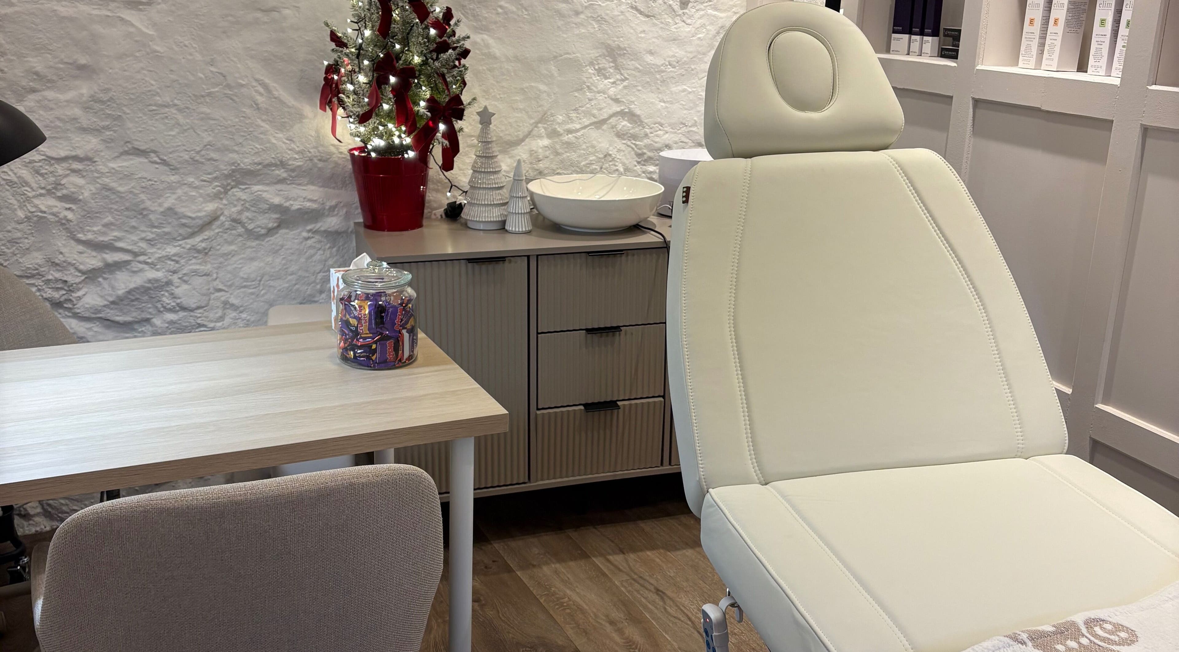 Calming therapy room at Made Creative Beauty, Rothley, England, GB with a cozy chair and festive decor.