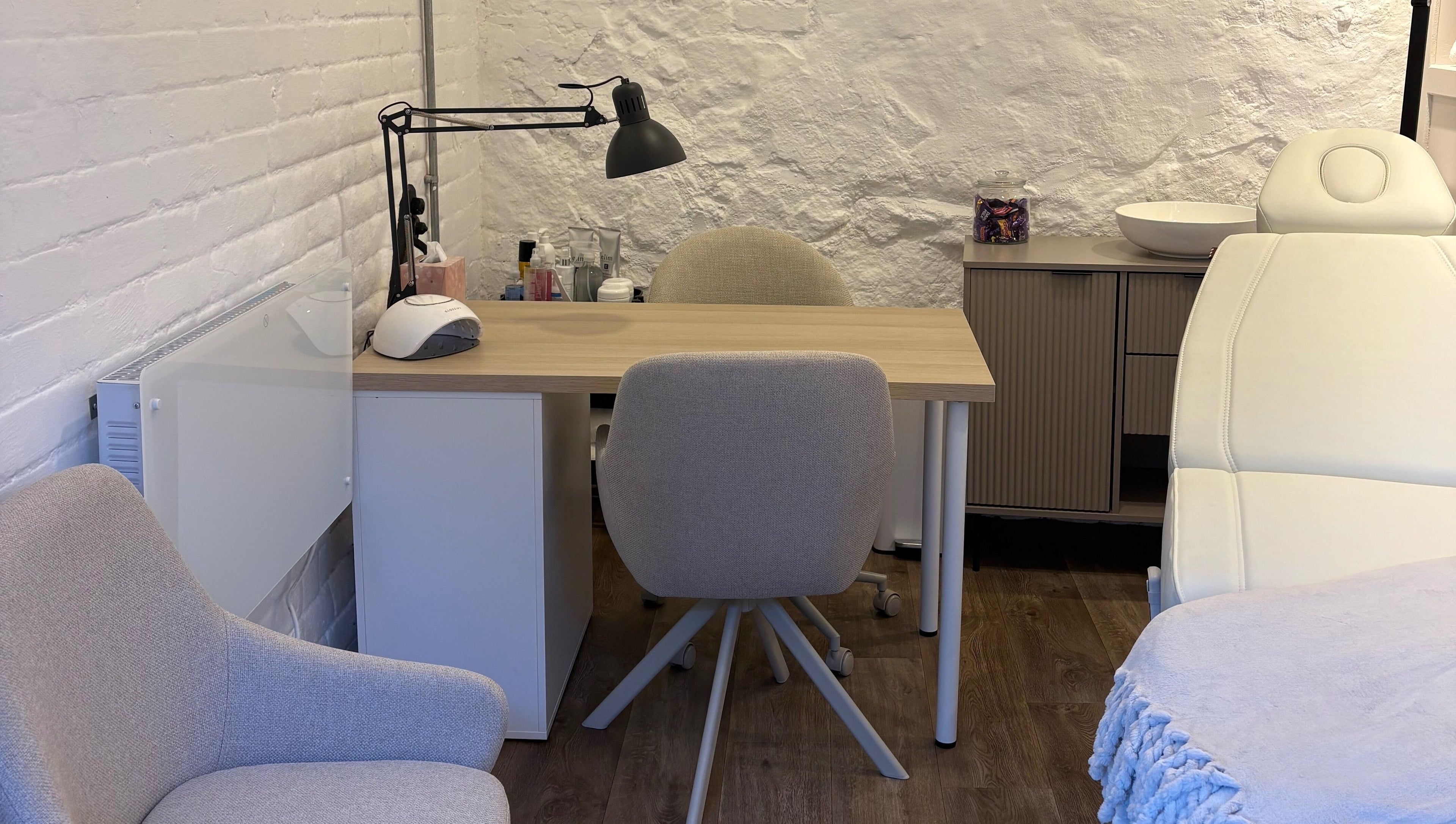 Cozy treatment area at Made Creative Beauty, Rothley, England, GB with a massage chair and desk setup.