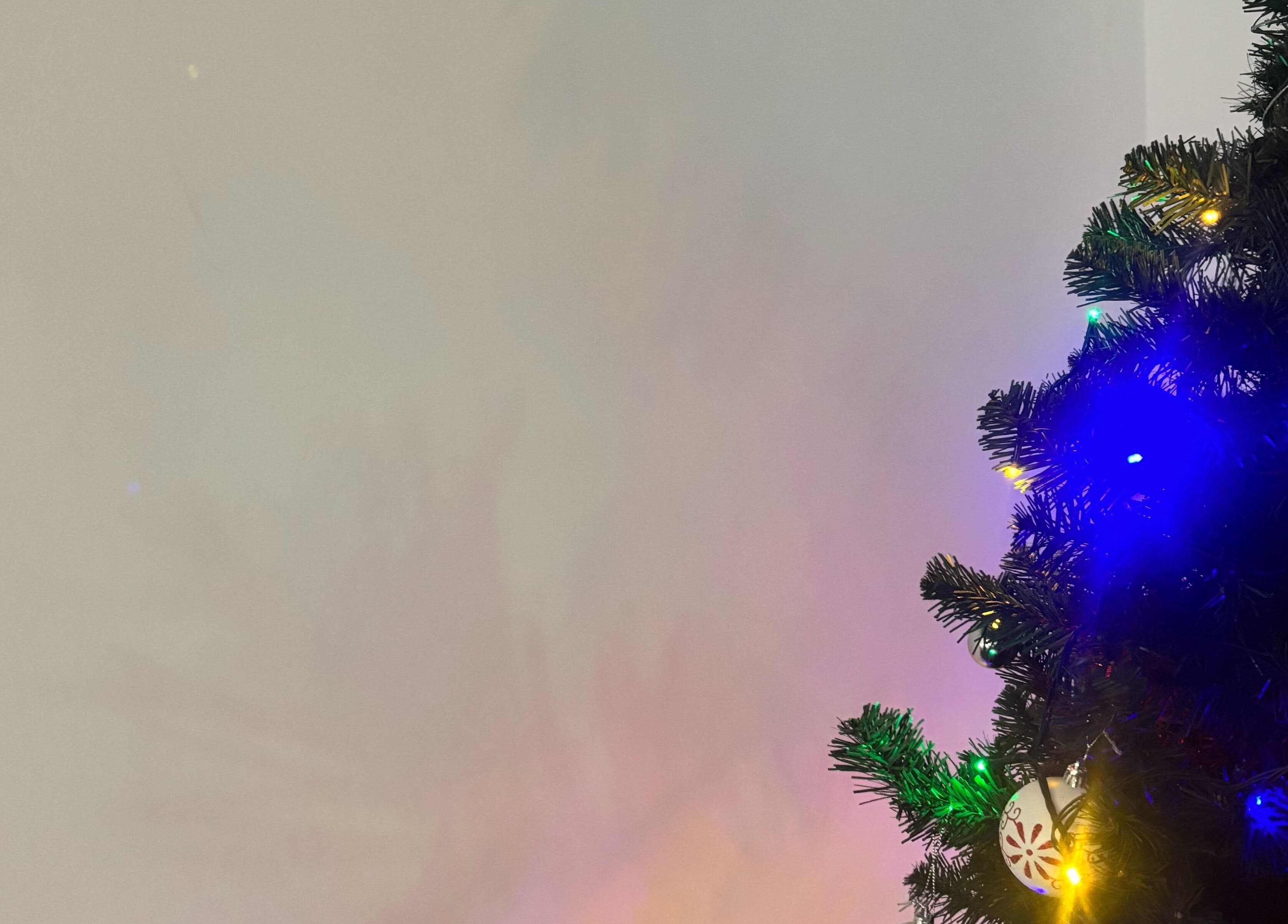 Christmas tree with colorful lights and ornaments at TGLAMHAUS, Peterborough, England, GB.